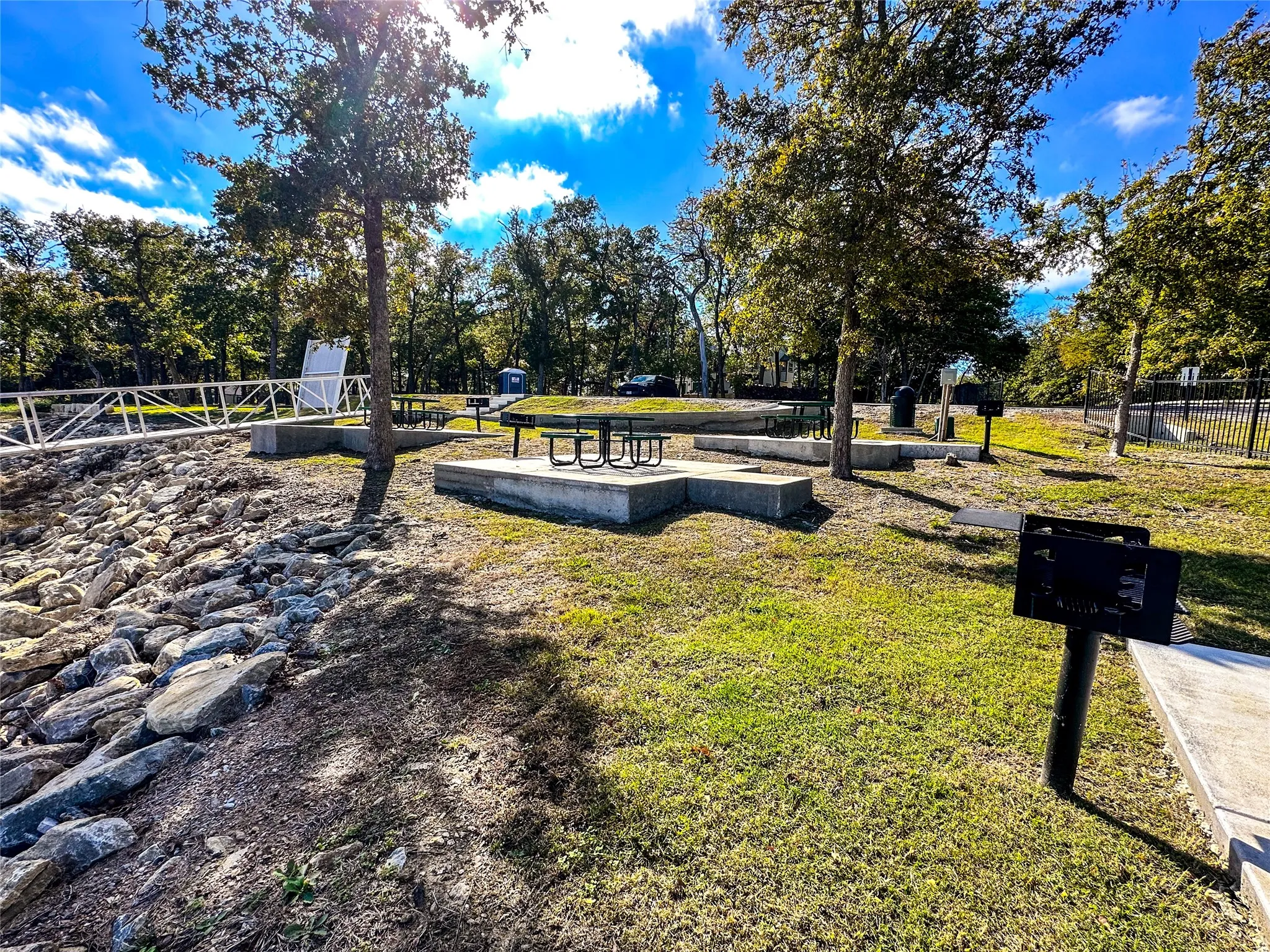 Community dock walkway complete with outdoor picnic tables, seating, and lake access.