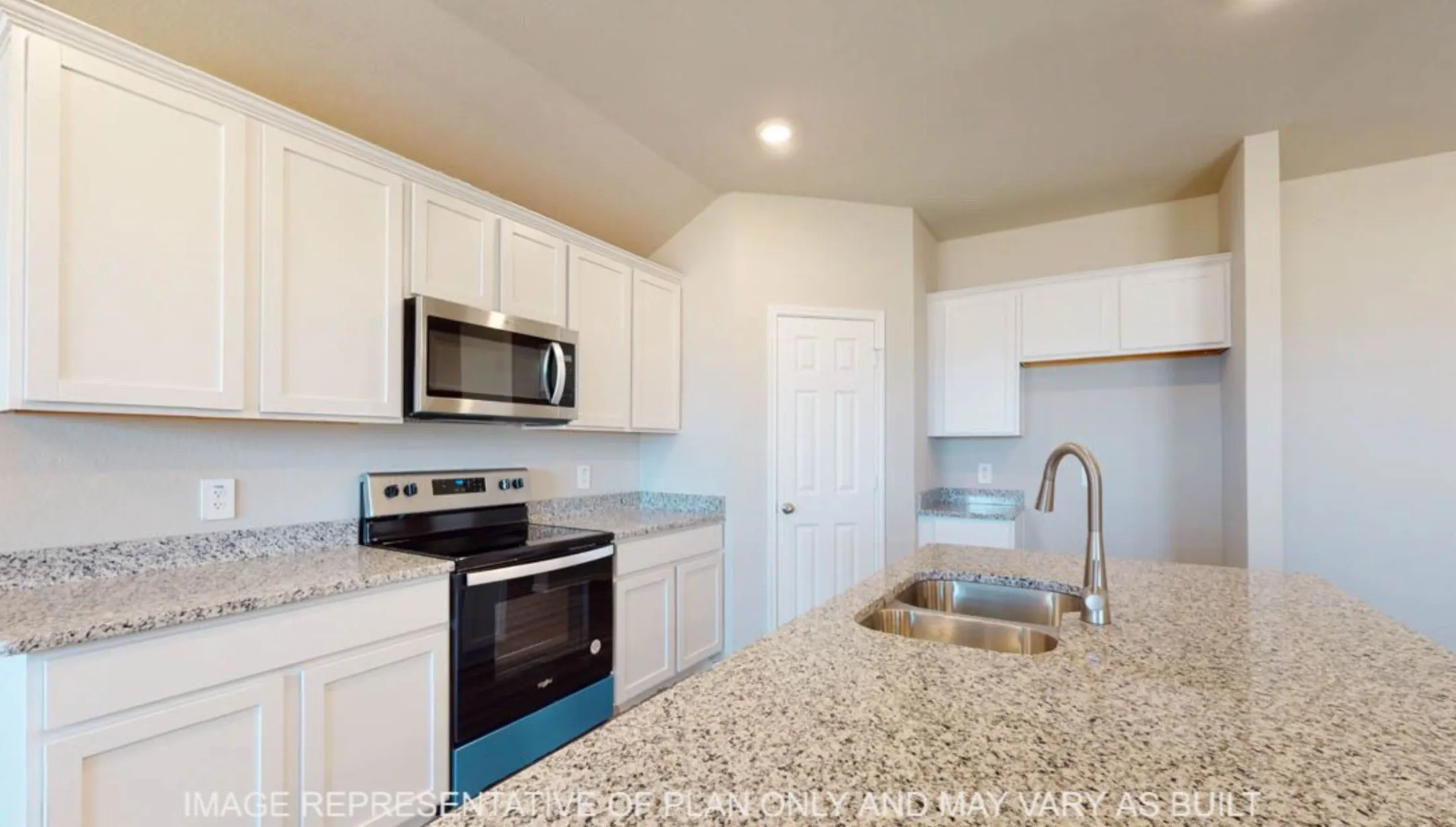 Kitchen featuring light-toned cabinetry, speckled countertops, stainless steel appliances, and a double basin sink with a gooseneck faucet