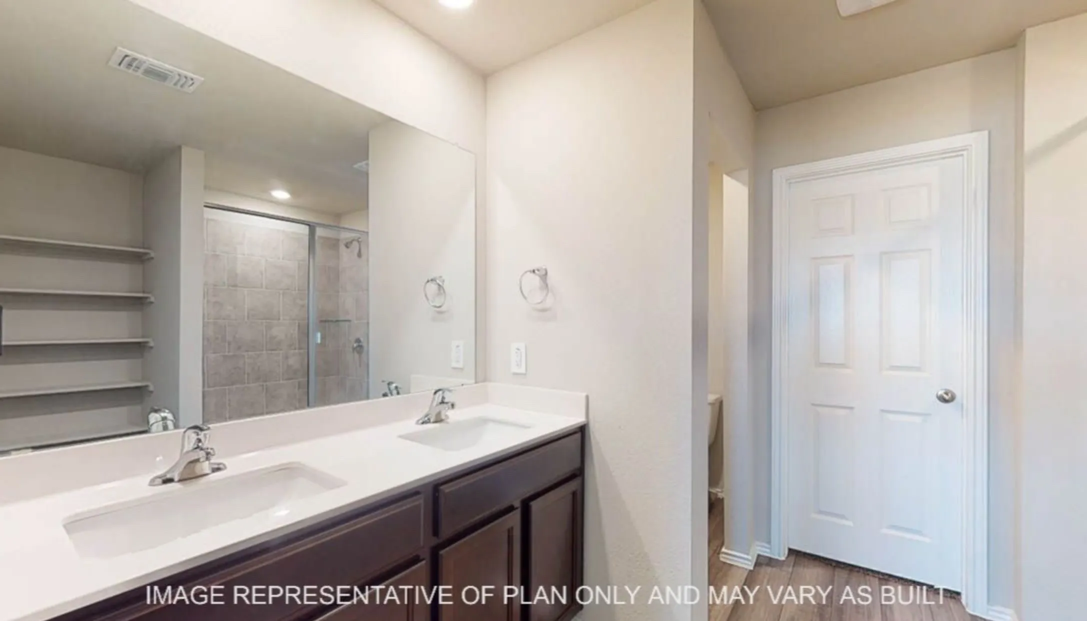 Dual vanity with undermount sinks, chrome fixtures, and a white countertop