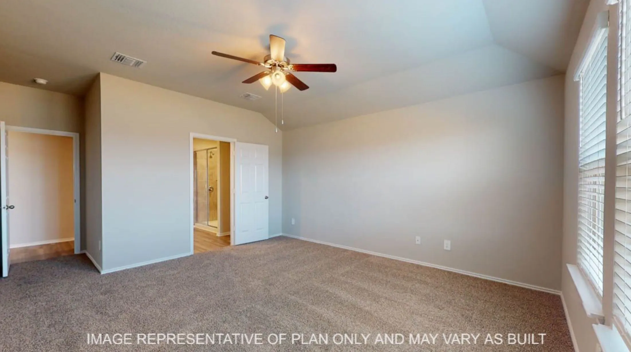 Spacious room featuring vaulted ceilings, neutral-toned carpeting, and a ceiling fan with integrated lighting