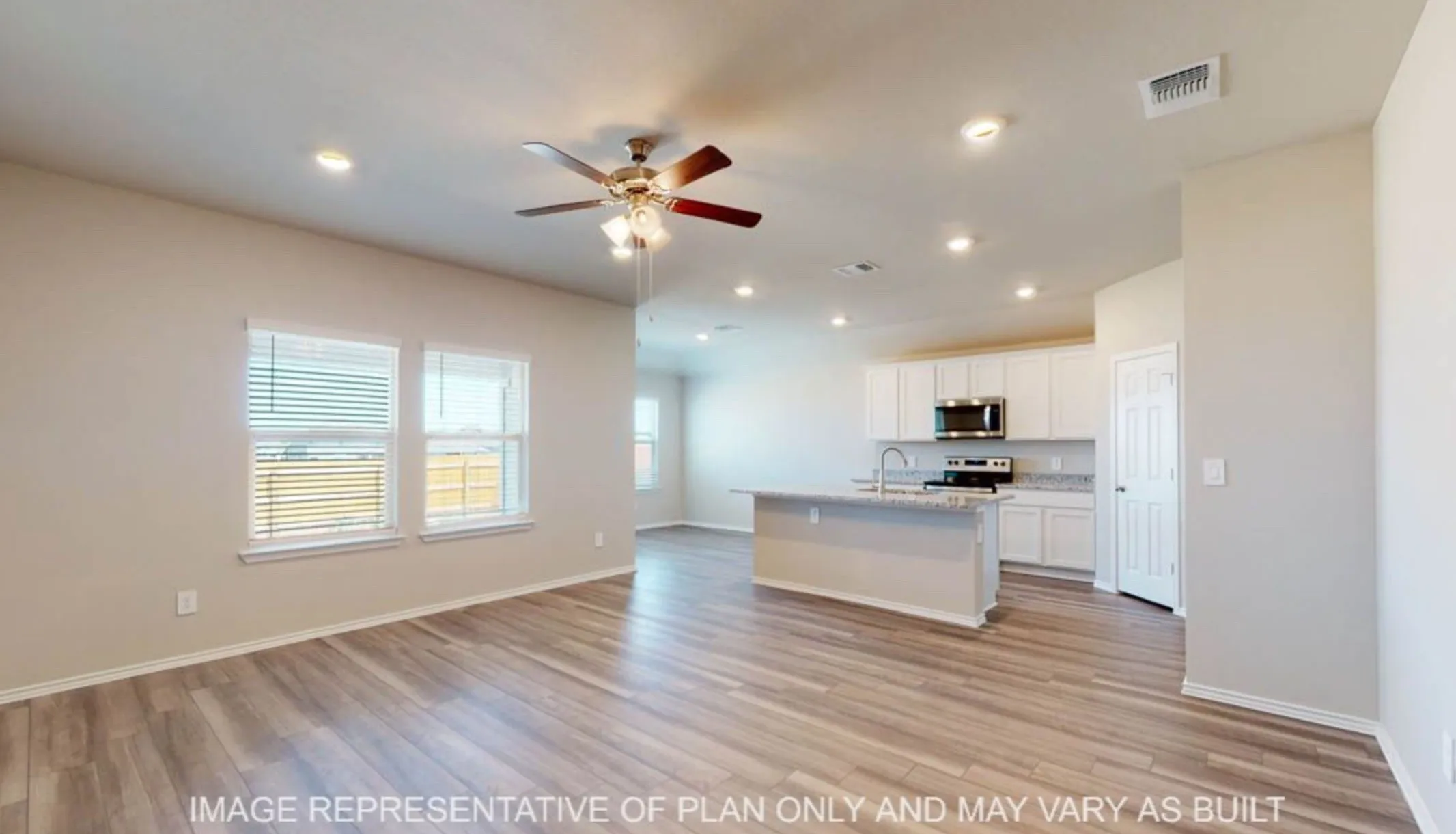 Open-concept living space featuring wood-finish flooring, recessed lighting, and a ceiling fan