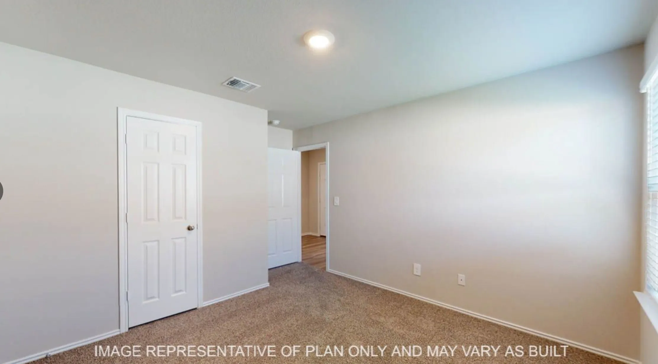 Carpeted room with light neutral wall paint, white trim, and a white paneled door