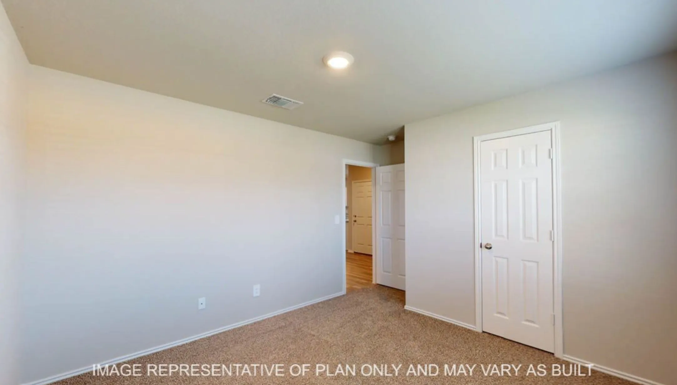 Carpeted room with light-colored walls and white trim