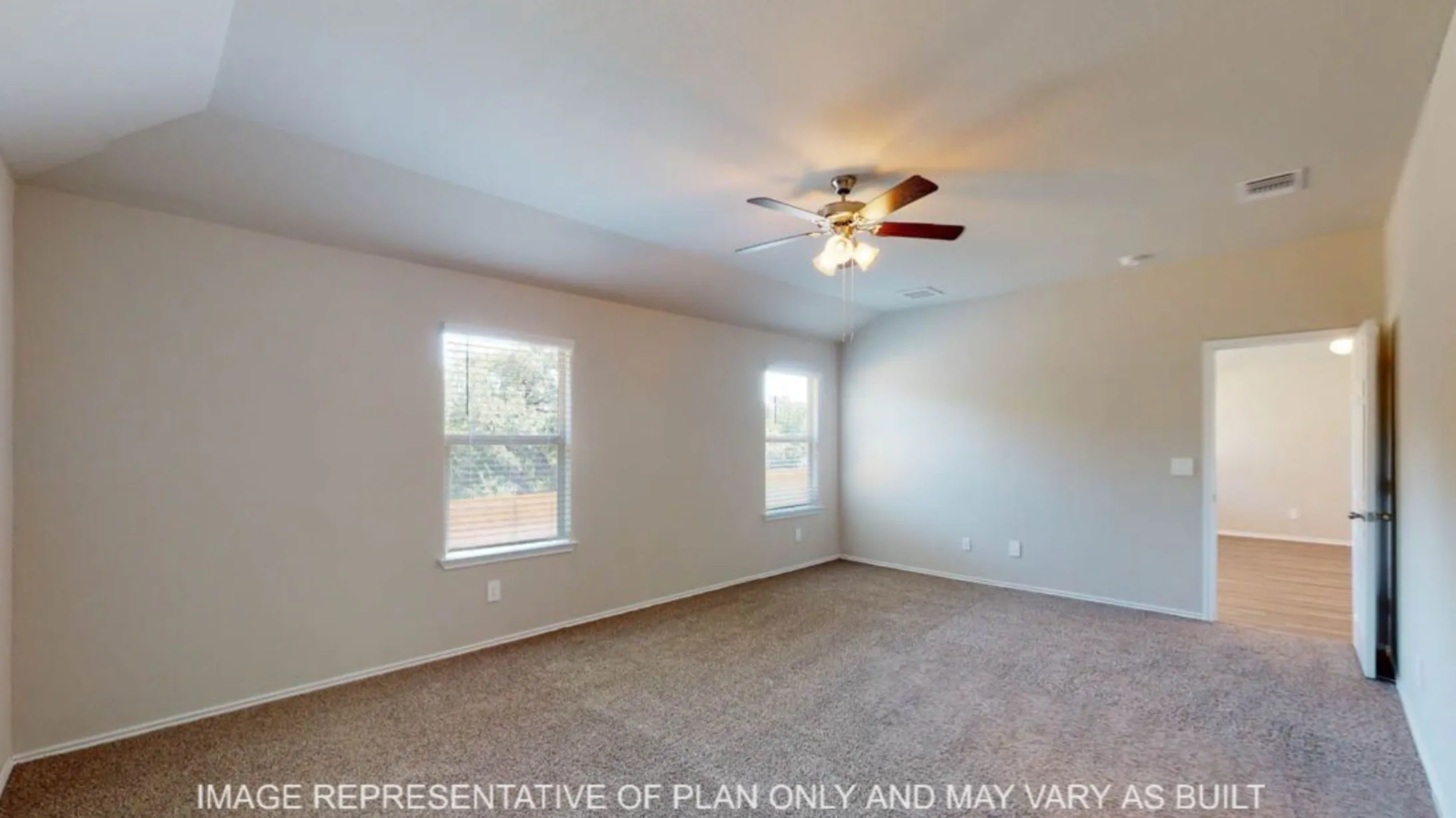 Spacious room featuring neutral carpeting and light-toned walls