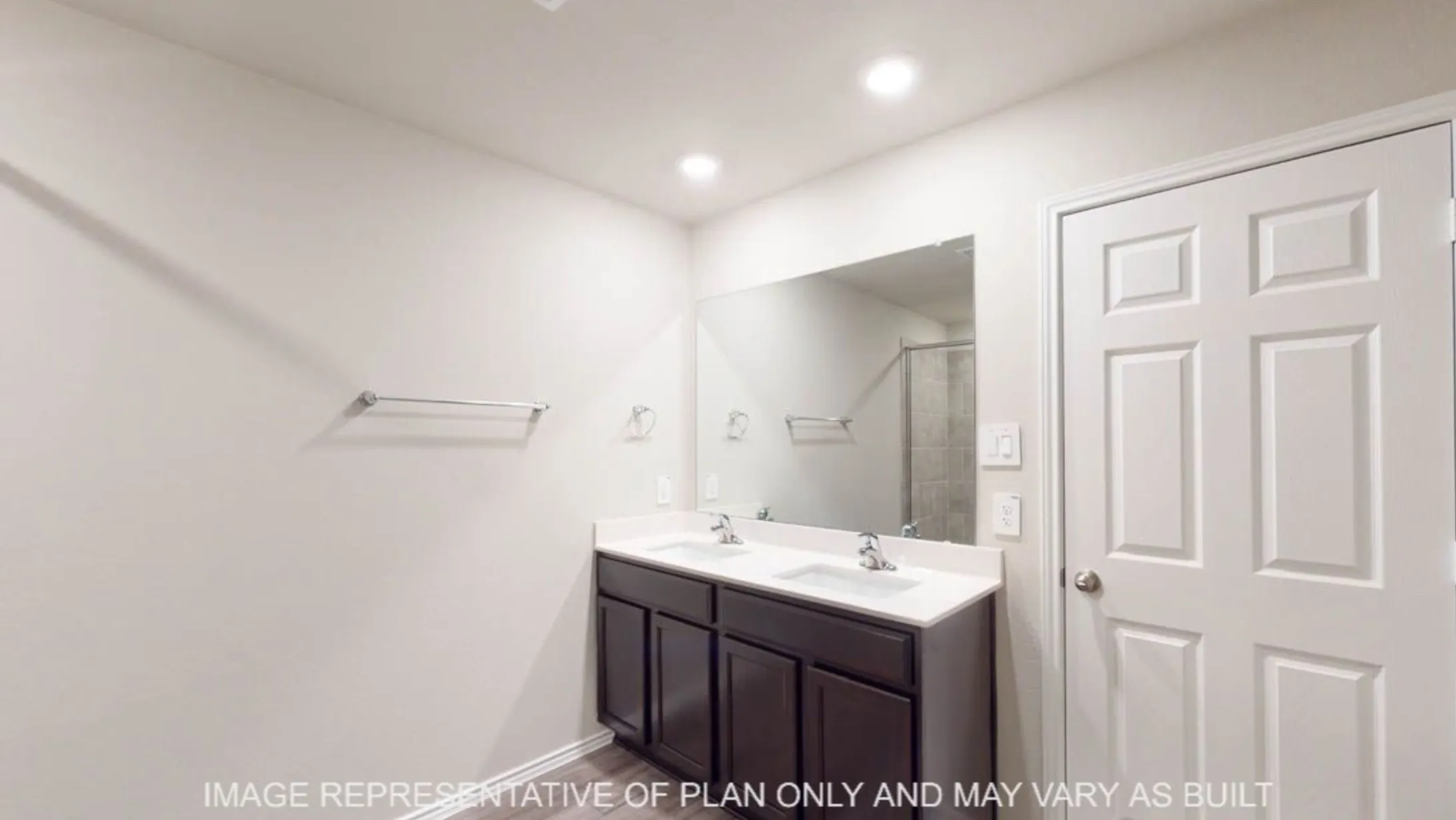 Dual vanity with dark wood-finish cabinetry, white countertop, and integrated sinks
