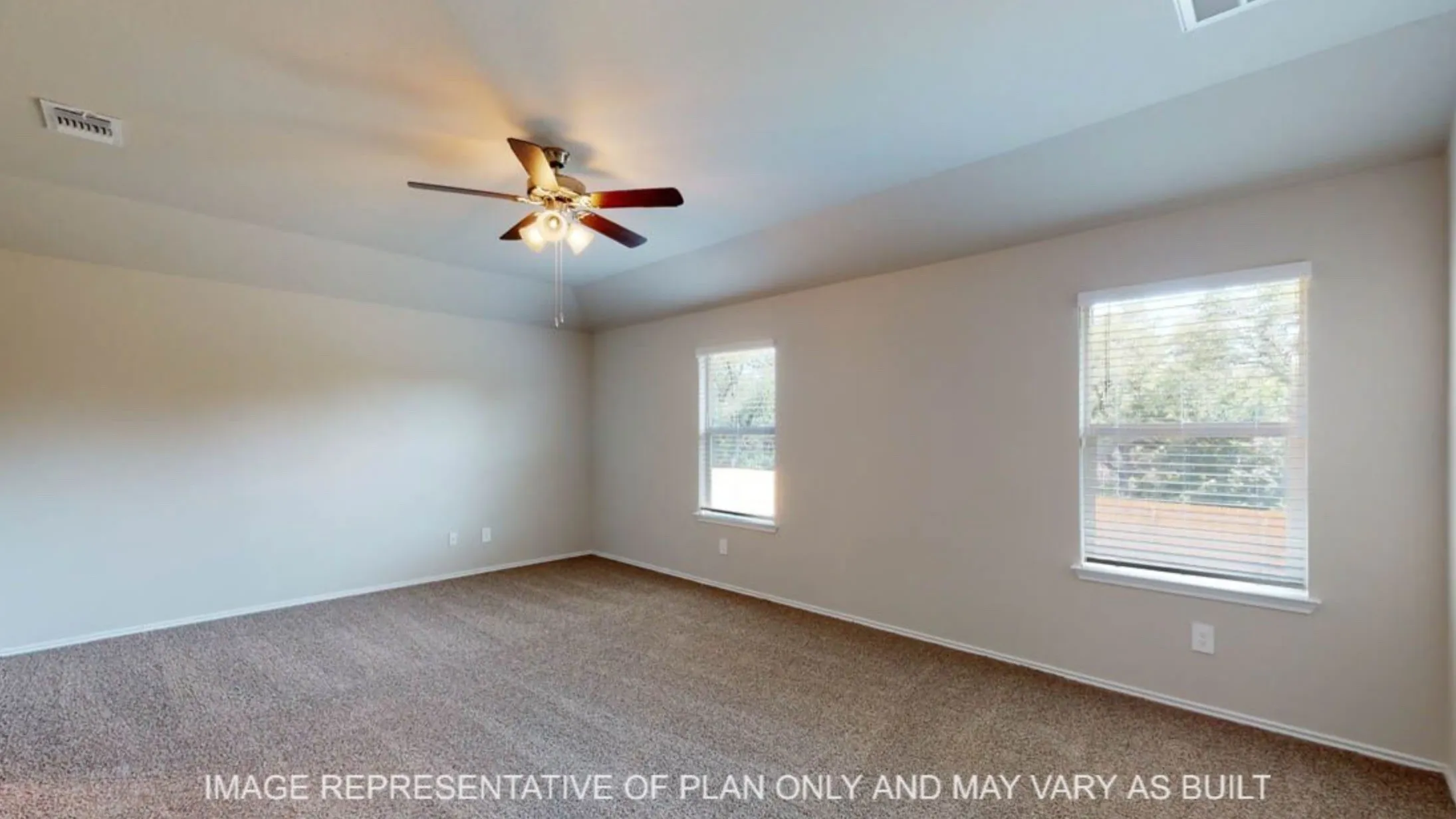 Spacious room with plush carpet flooring and neutral wall tones
