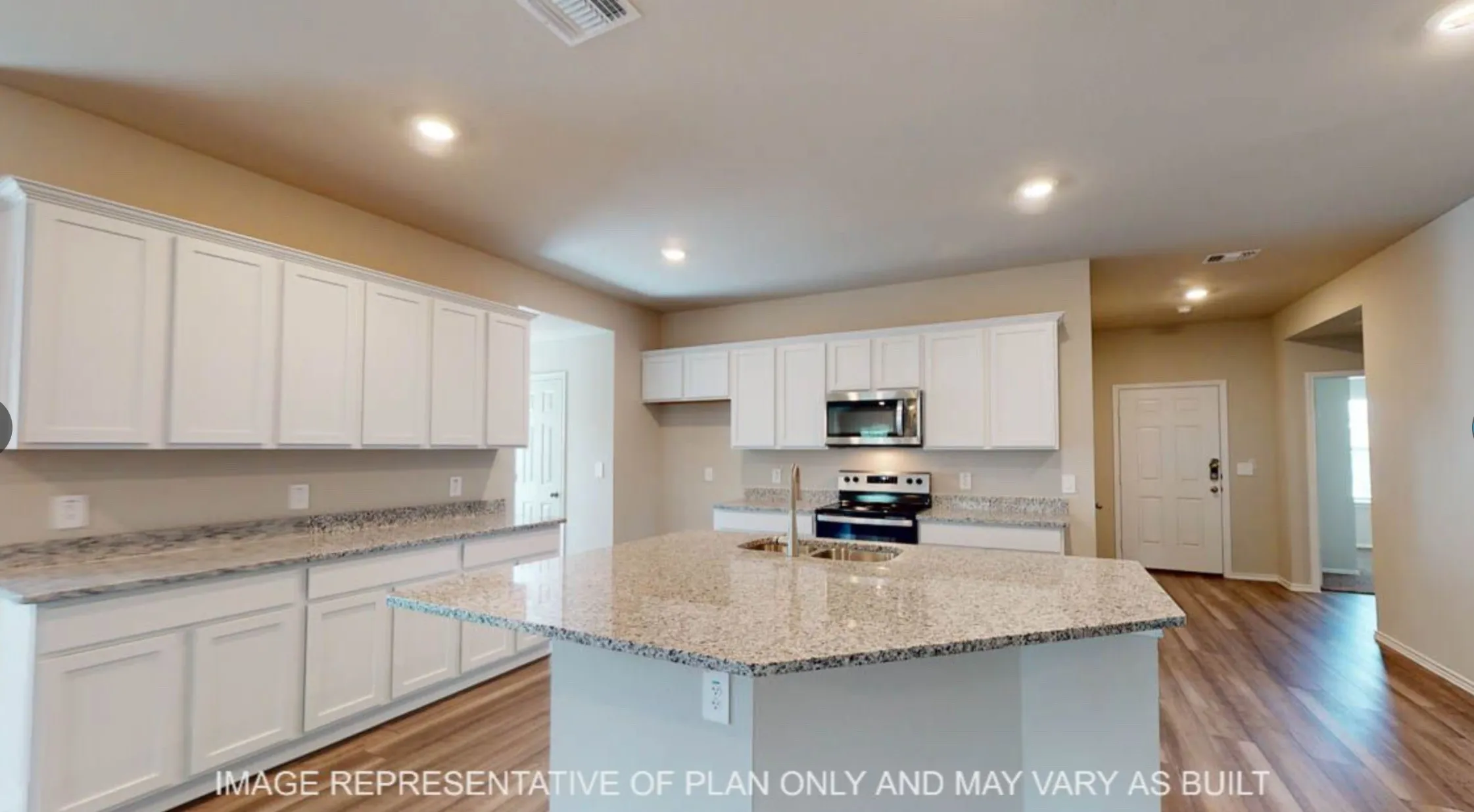 Kitchen featuring an expansive island with a stainless steel undermount sink, granite-style countertops, white shaker cabinetry, stainless steel appliances, and wood-finish flooring