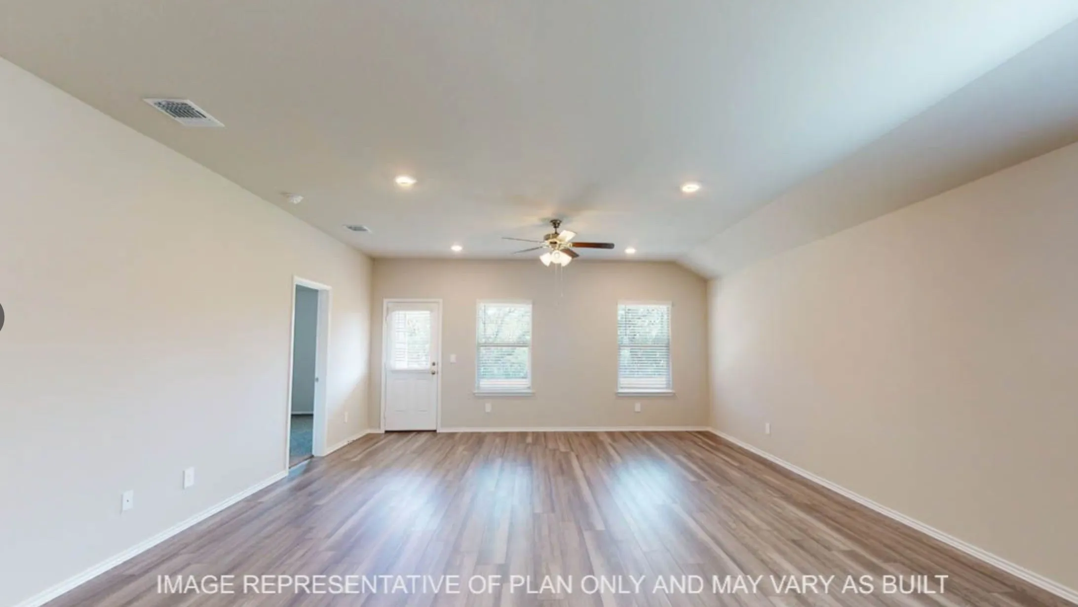 Spacious room featuring wood-finish flooring, neutral-toned walls, a ceiling fan, recessed lighting, and multiple windows