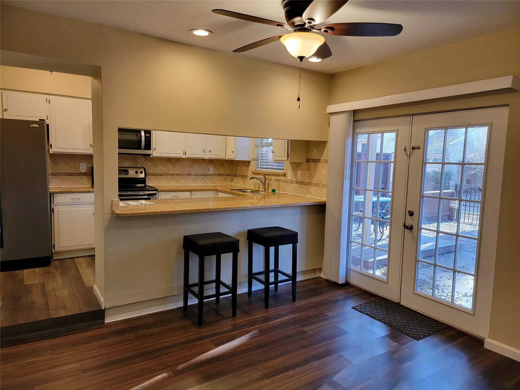 Dinning Room with Breakfast Bar and French Doors to Large Patio