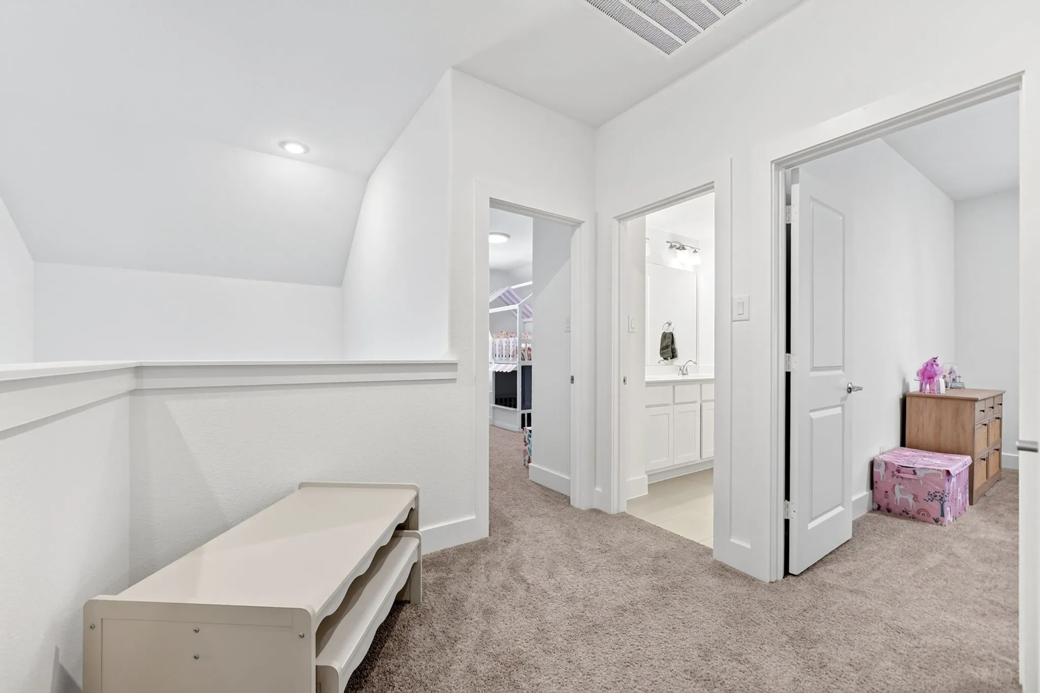 Upper-level hallway featuring plush carpeting, white walls, recessed lighting, and white trim
