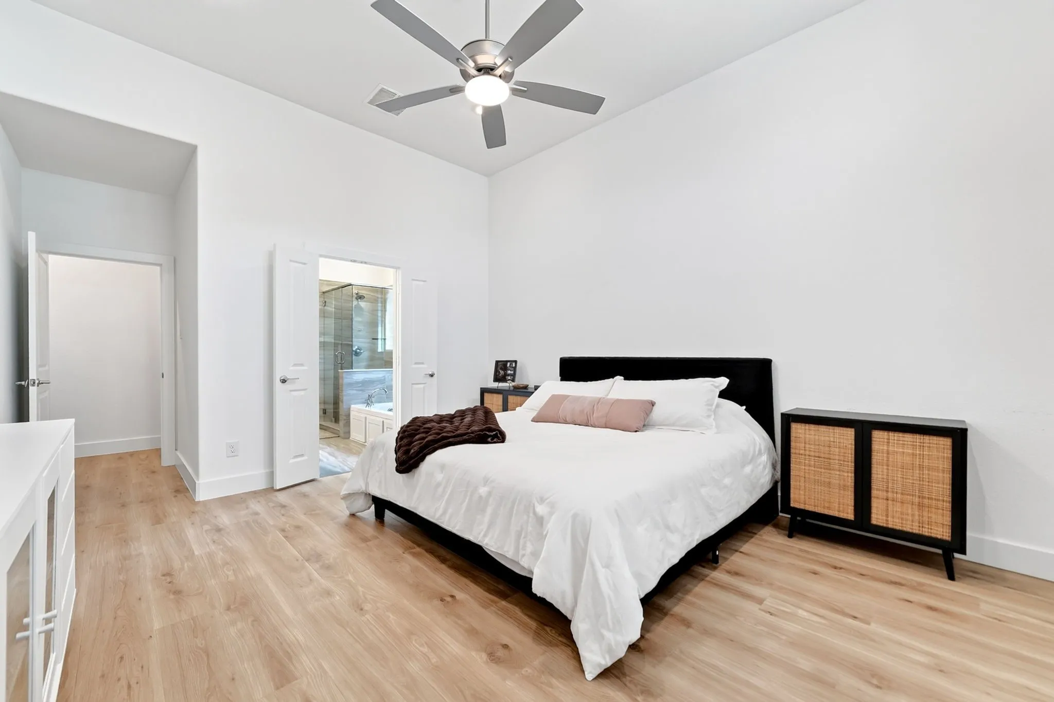 Light wood-finish flooring complements white walls and high ceilings