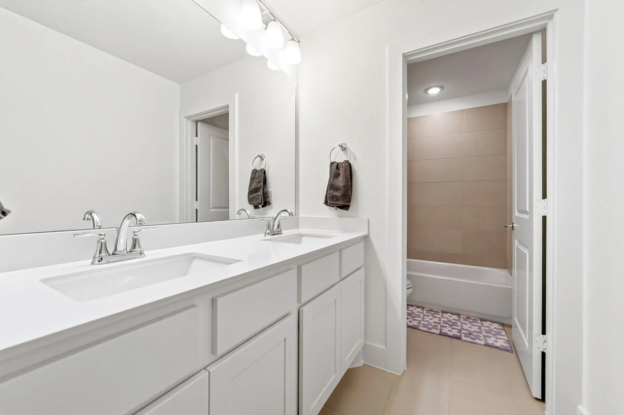 Dual vanity with white cabinetry and integrated sinks