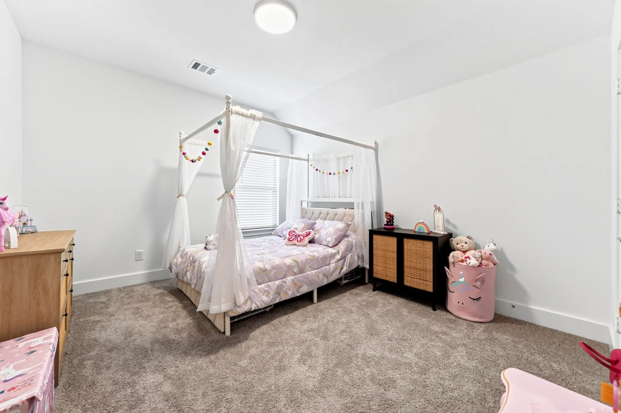 Carpeted room featuring a white baseboard, light gray wall paint, and a window with horizontal blinds