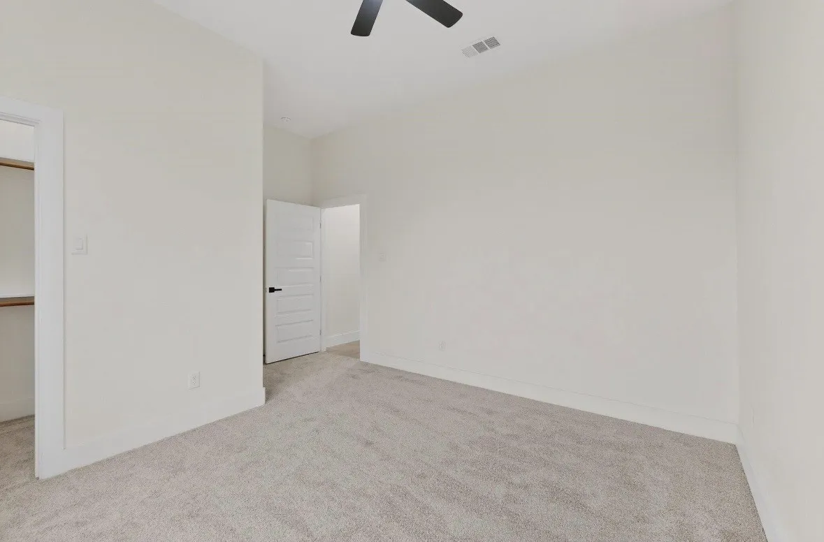 Neutral tone walls with light gray carpeting