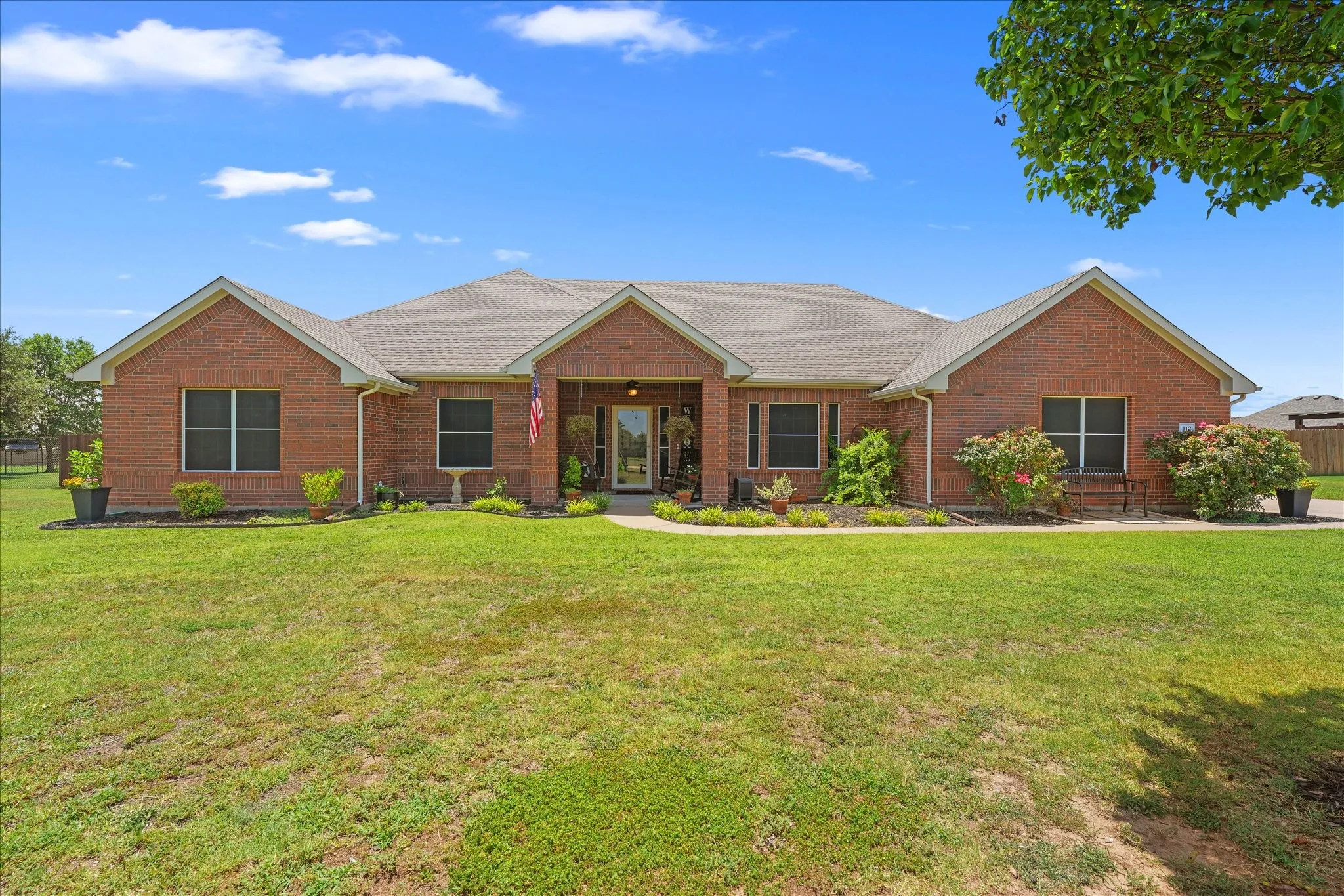 Brick exterior with a gabled roofline and an inviting covered front porch