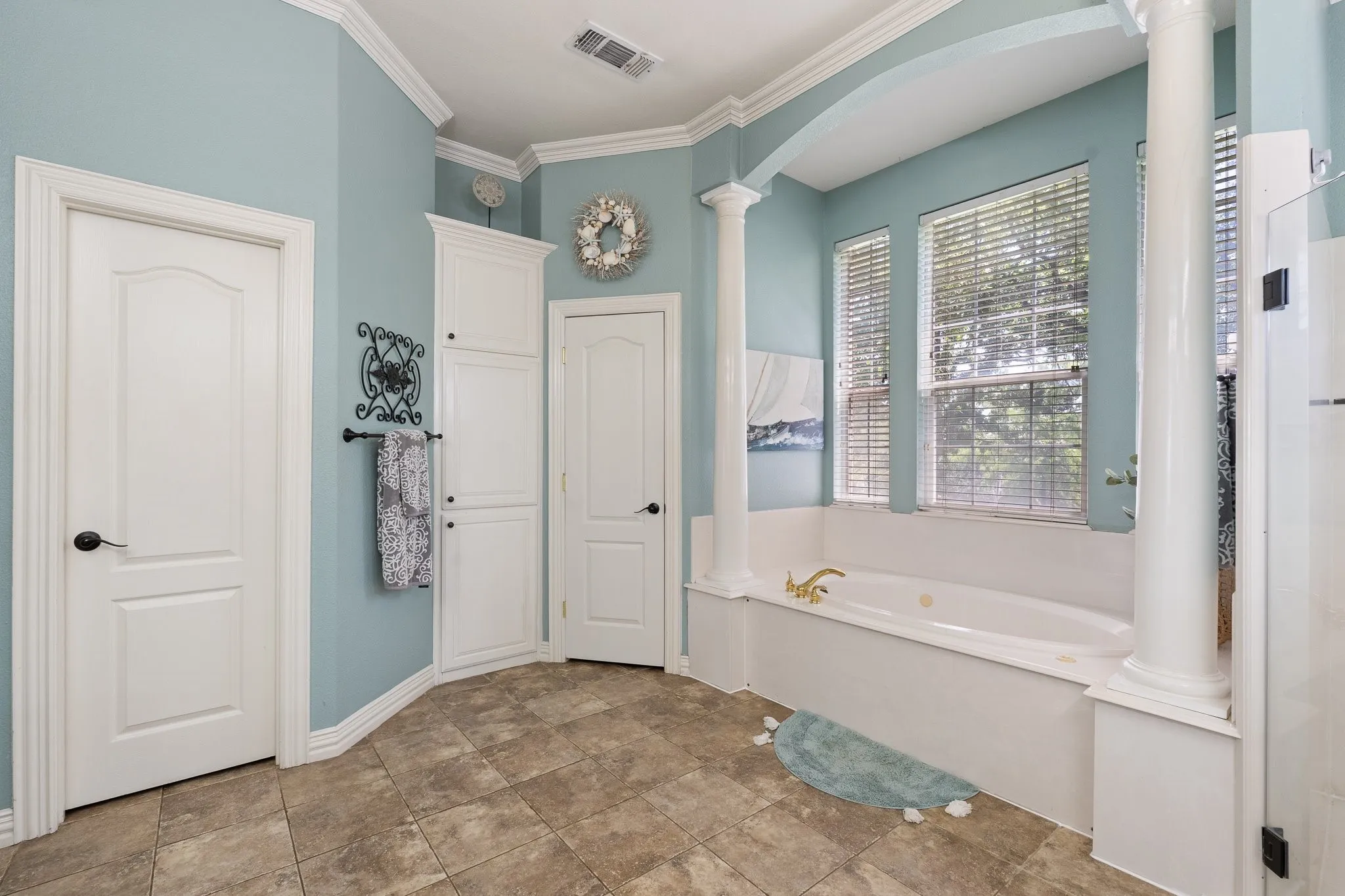 Built-in jetted tub surrounded by three large windows