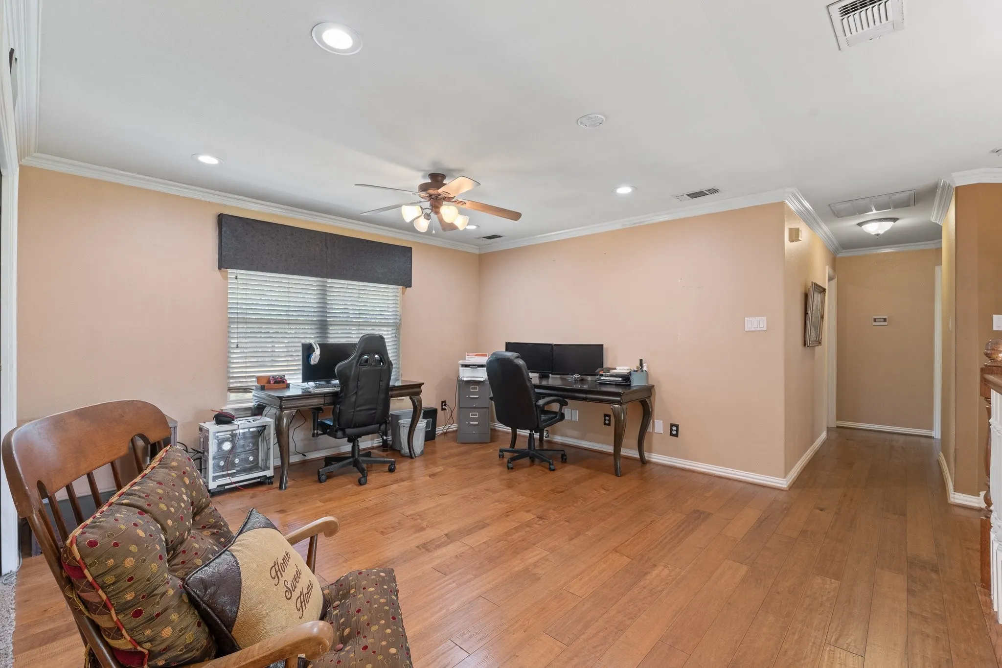 Spacious den, game room or flex space featuring wood-finish flooring, recessed lighting, and a ceiling fan