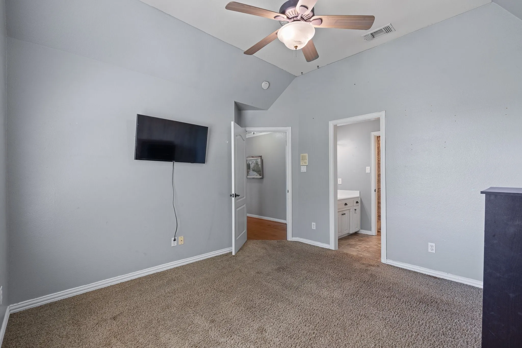 Vaulted ceiling room with recessed lighting and a ceiling fan