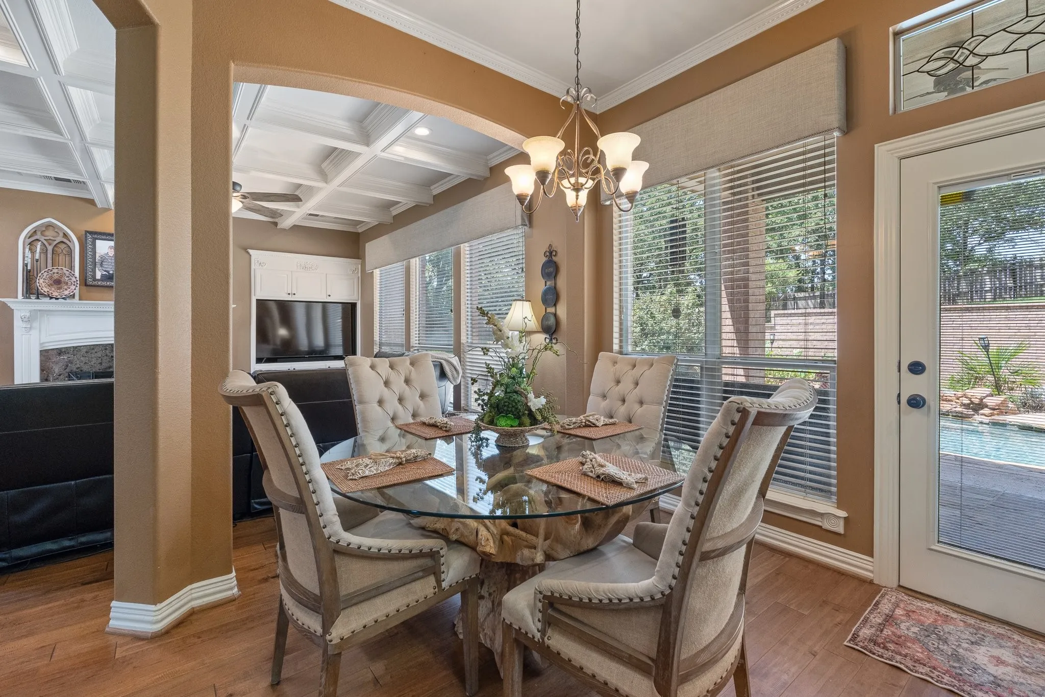 Breakfast area featuring wood flooring and direct access to an outdoor patio with a gorgeous pool
