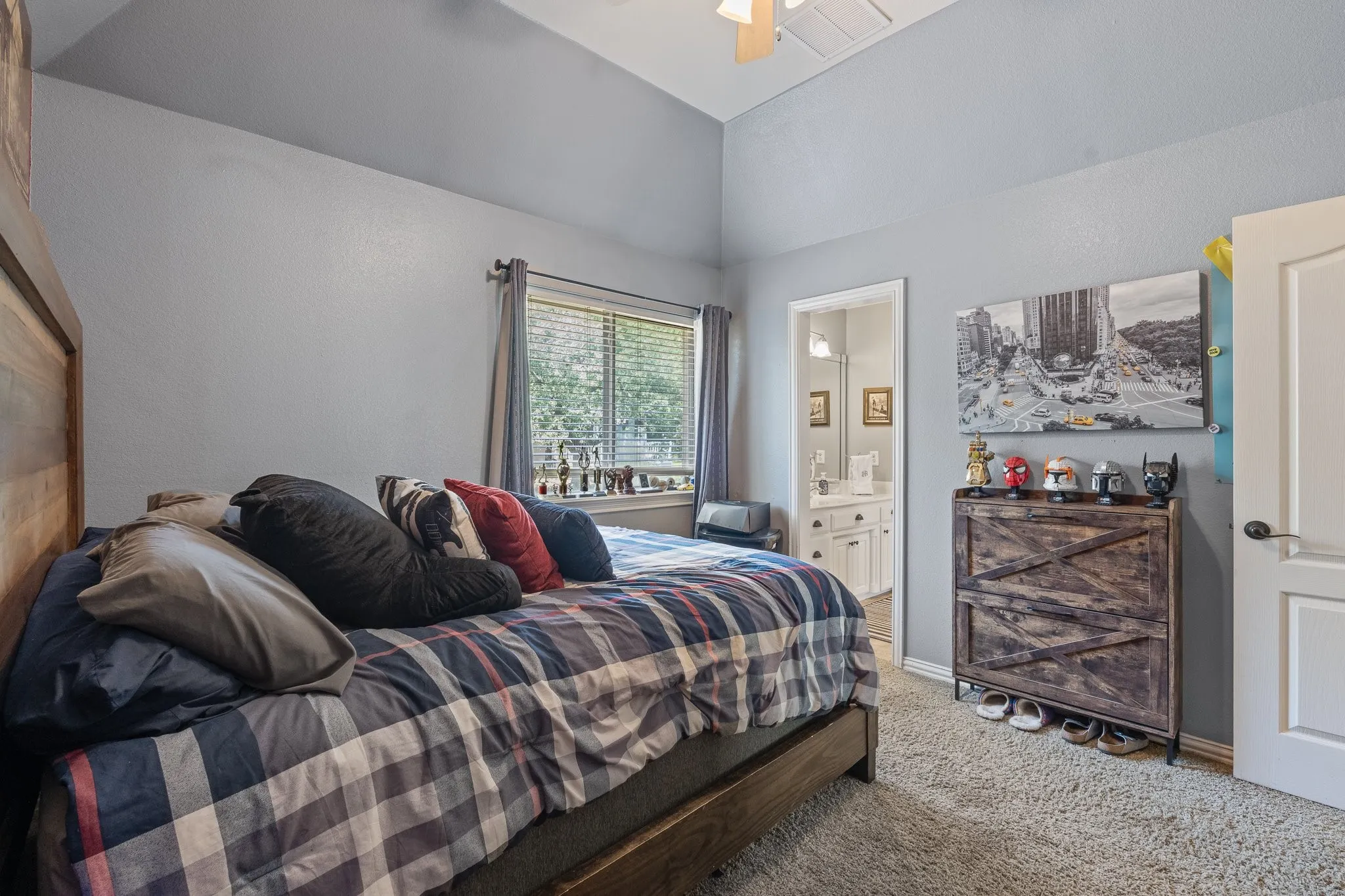 Bedroom featuring vaulted ceilings, a window with blinds, and carpet