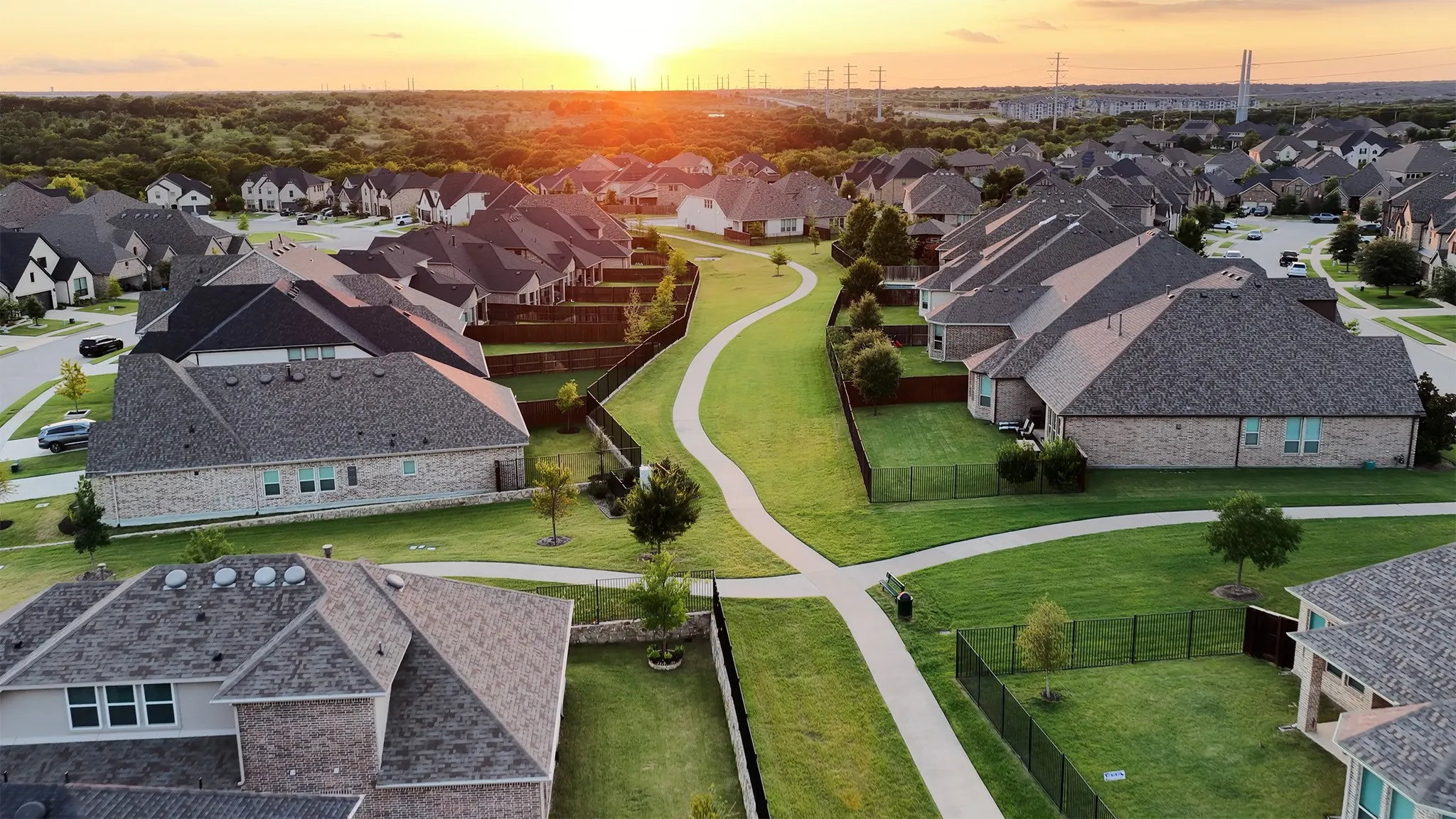 Aerial view of neighborhood showcasing sunset beauty and extensive network of trails throughout.