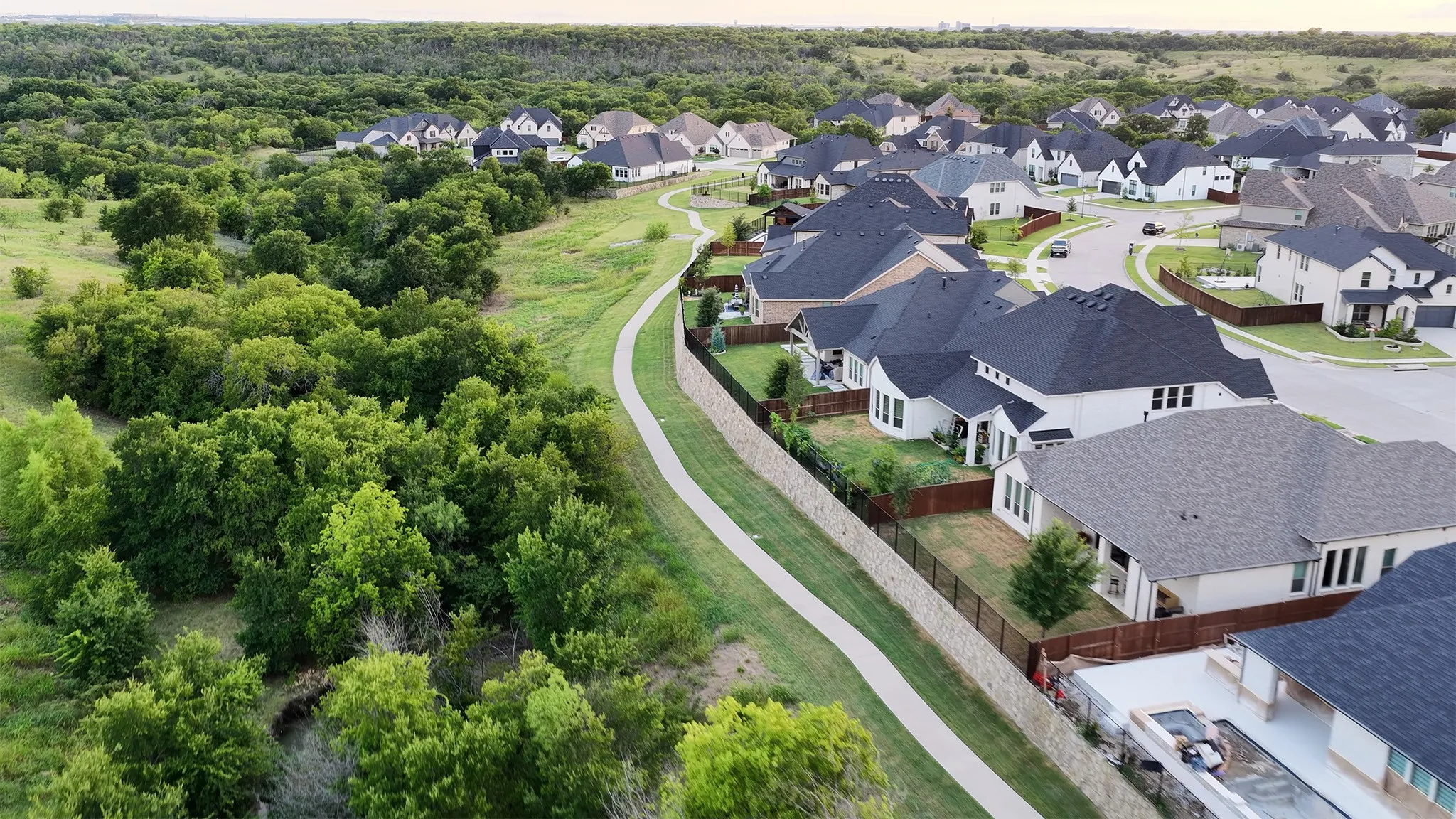 Aerial view of the neighborhood showing the greenspace and extensive trails leading to the community pool.