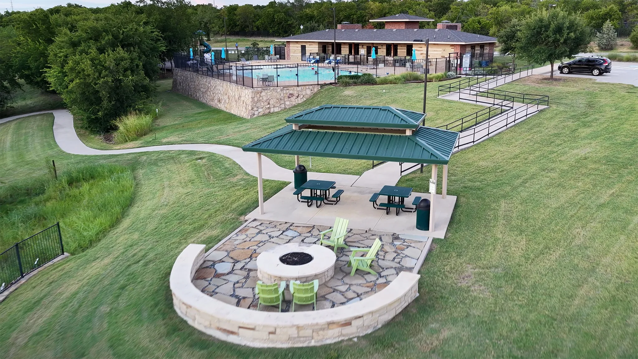 Covered patio and community grill near the neighborhood pool and trail.