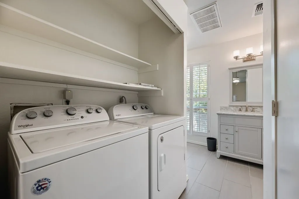 Dedicated laundry area with built-in shelving, providing convenient storage