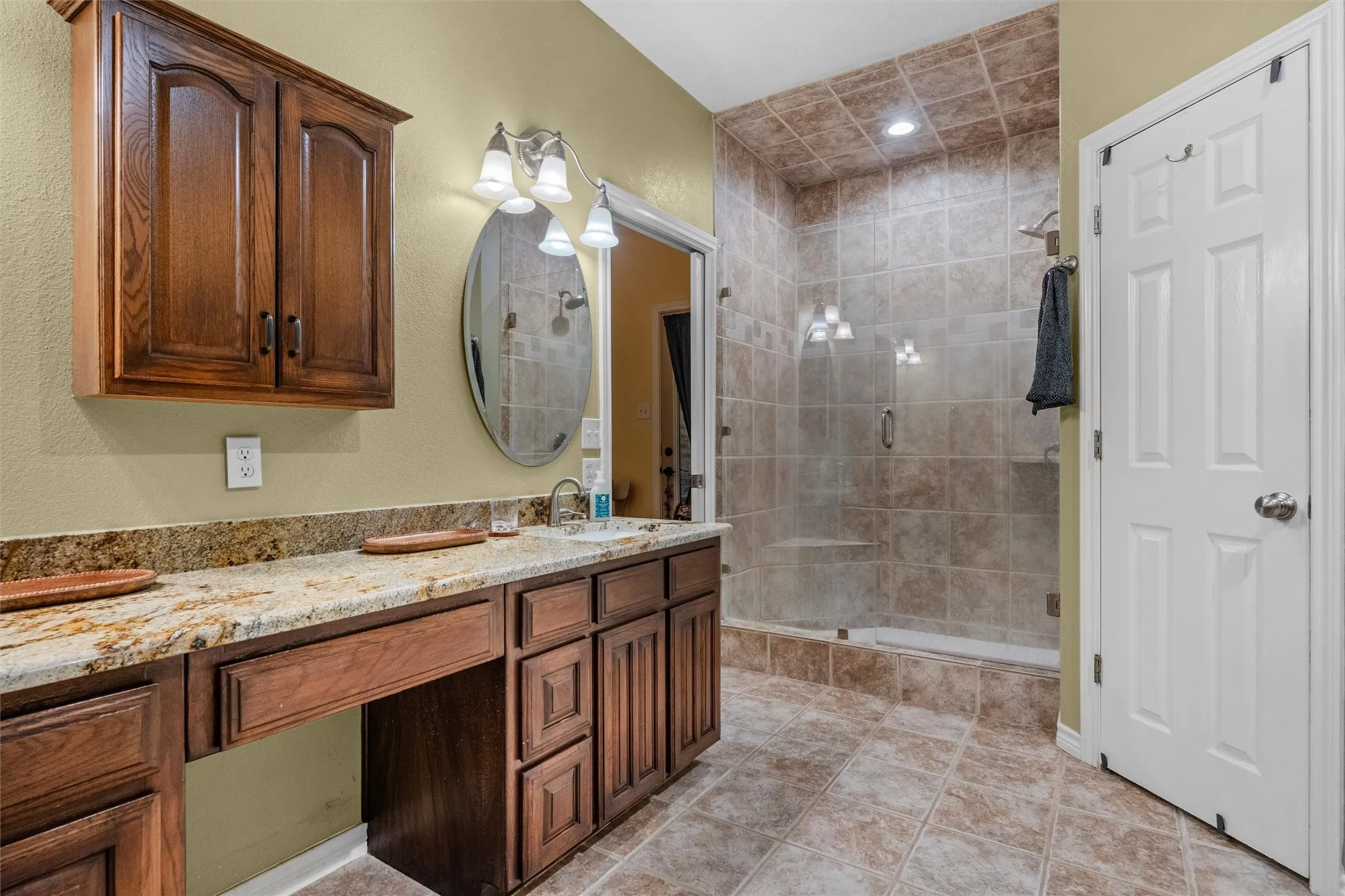 Walk-in shower with full tile surround and glass enclosure