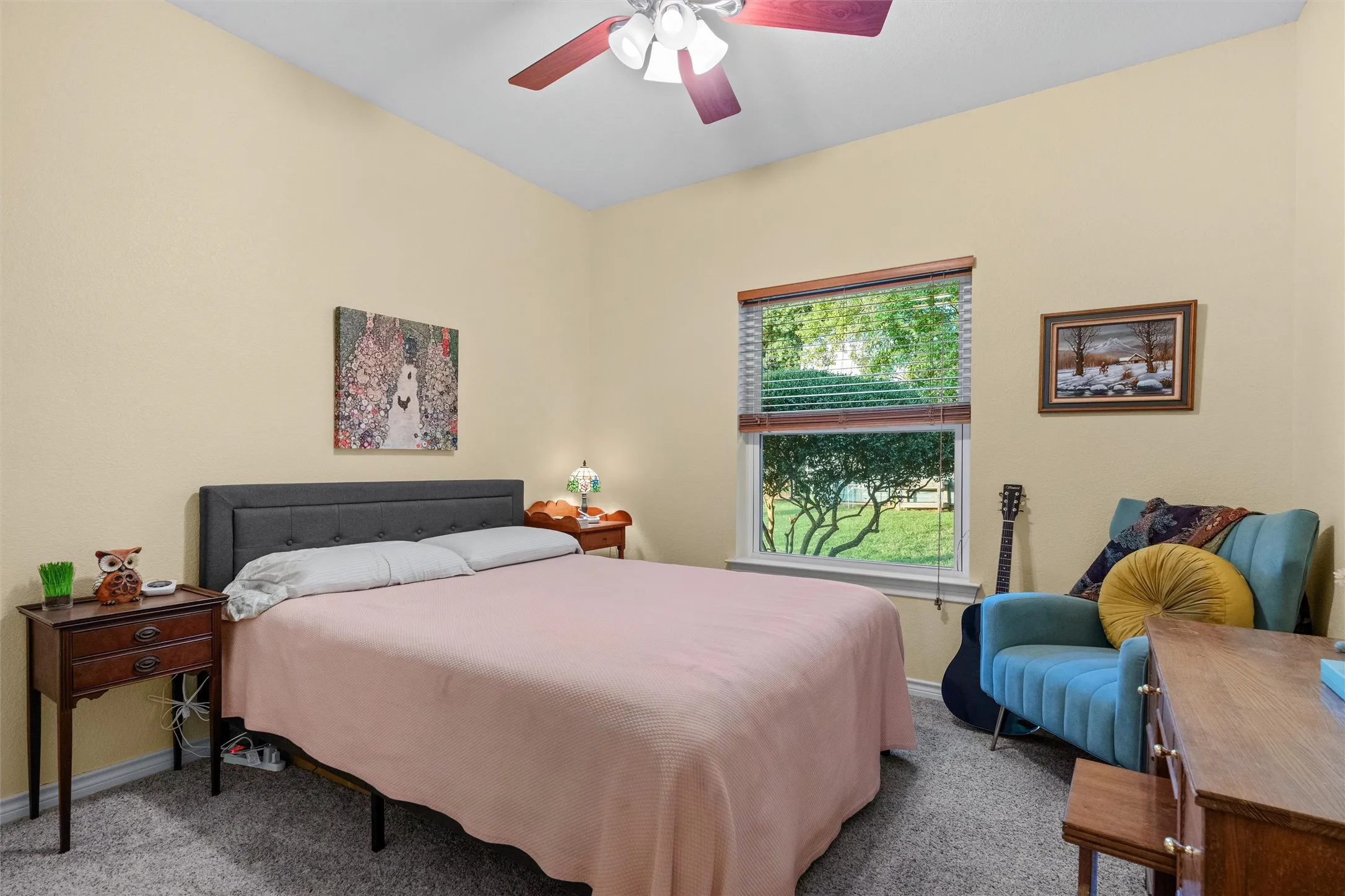 Carpeted room with a ceiling fan, a window featuring blinds, and light-colored walls