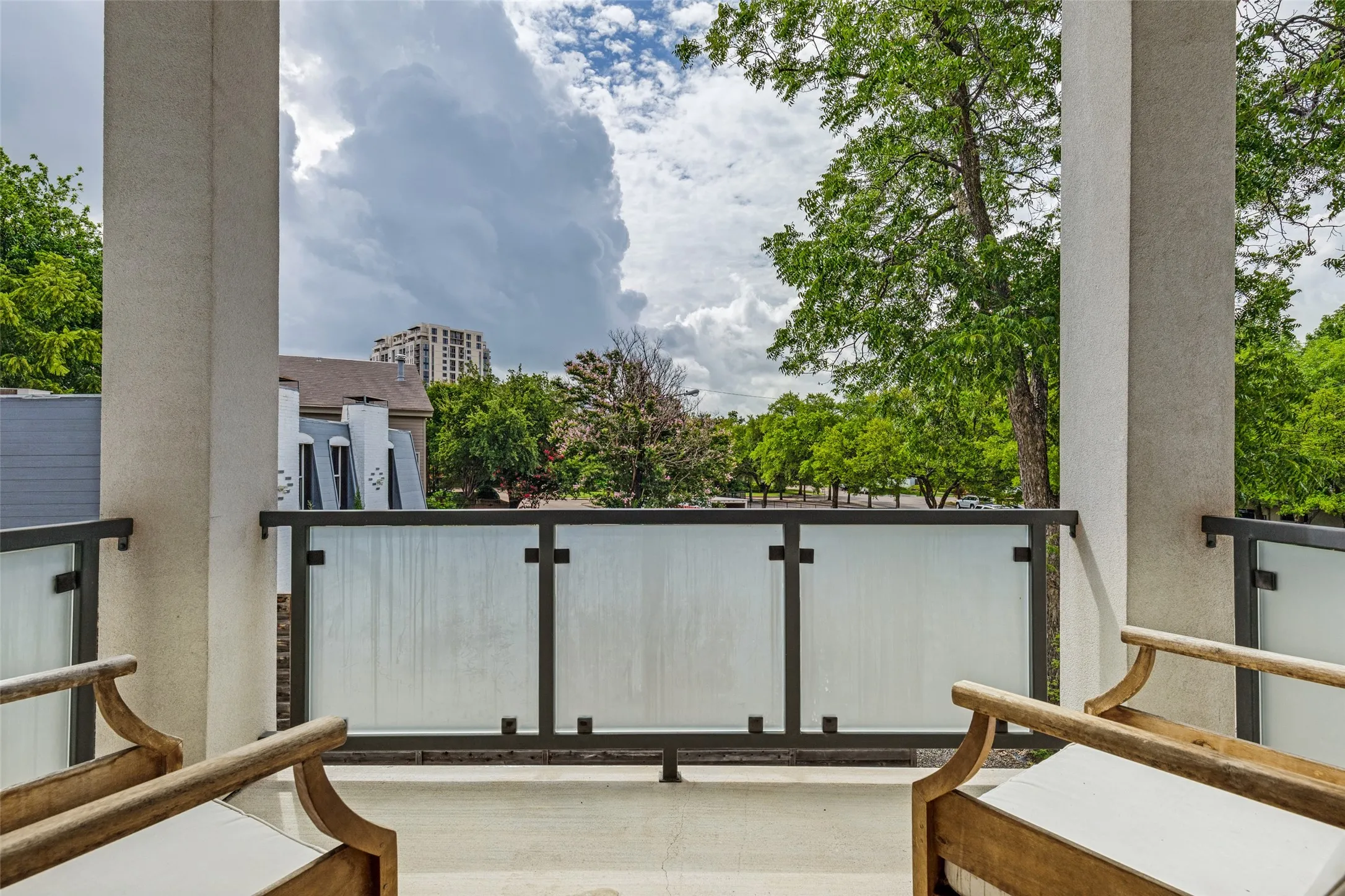 Outdoor balcony with frosted glass and metal railing