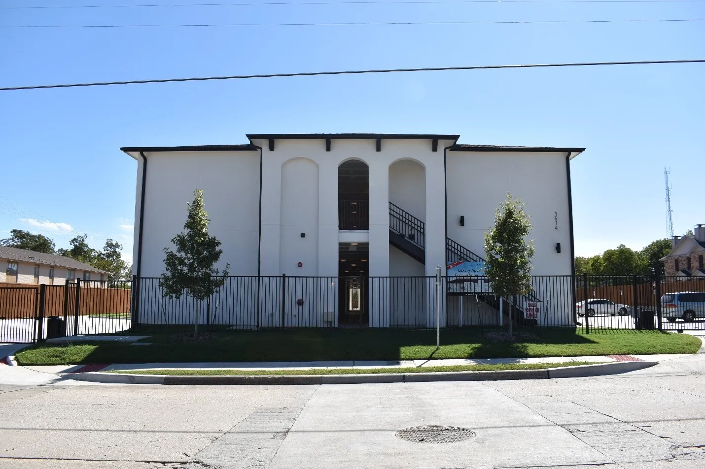 Contemporary stucco exterior with prominent arched entryway