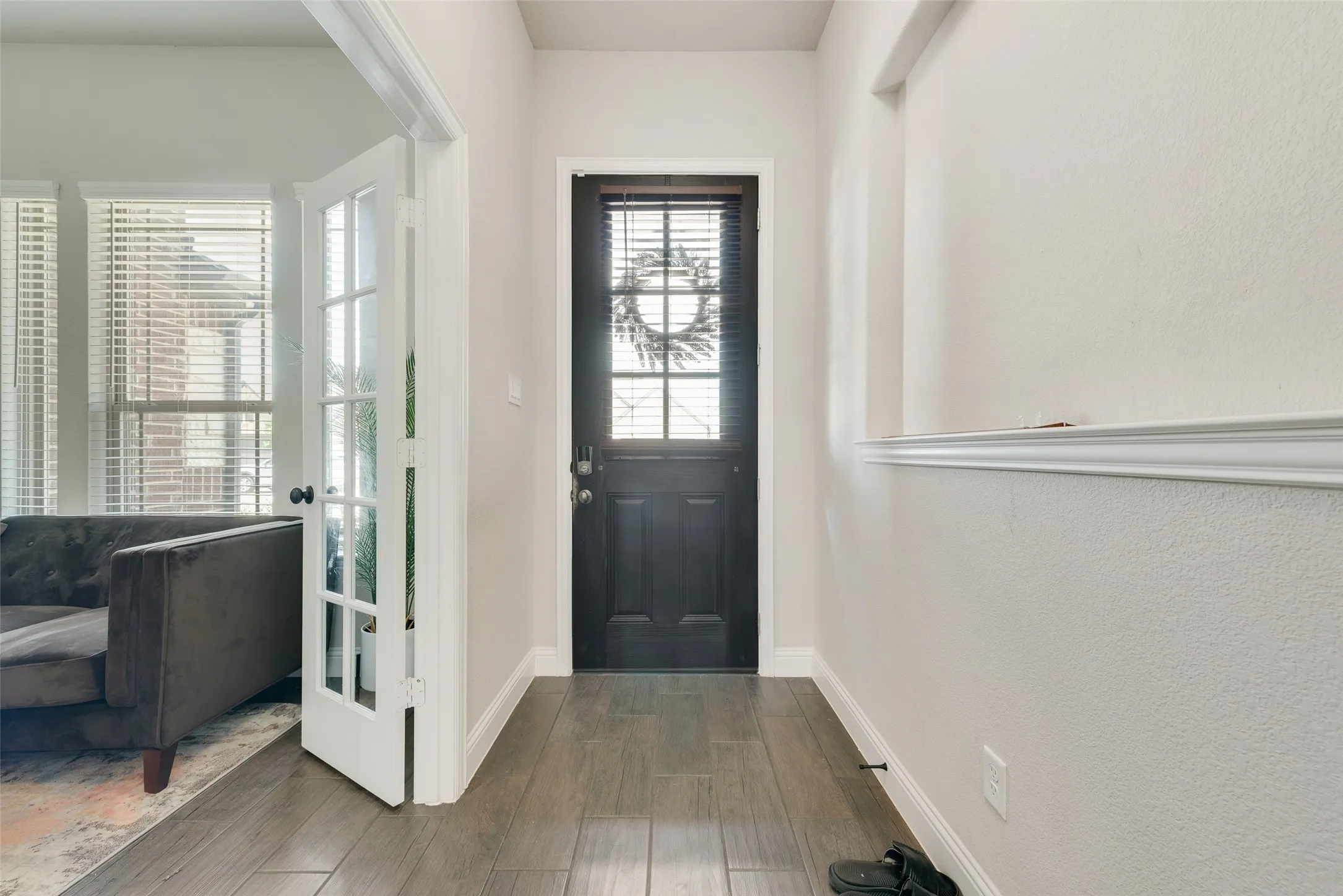 Foyer entrance featuring wood finished floors and baseboards