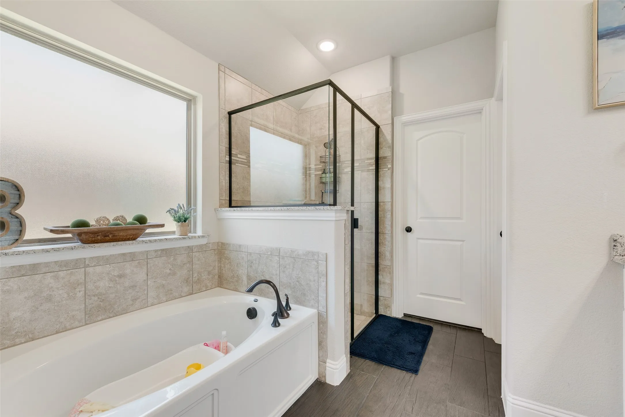 Bathroom with a bath and a stall shower