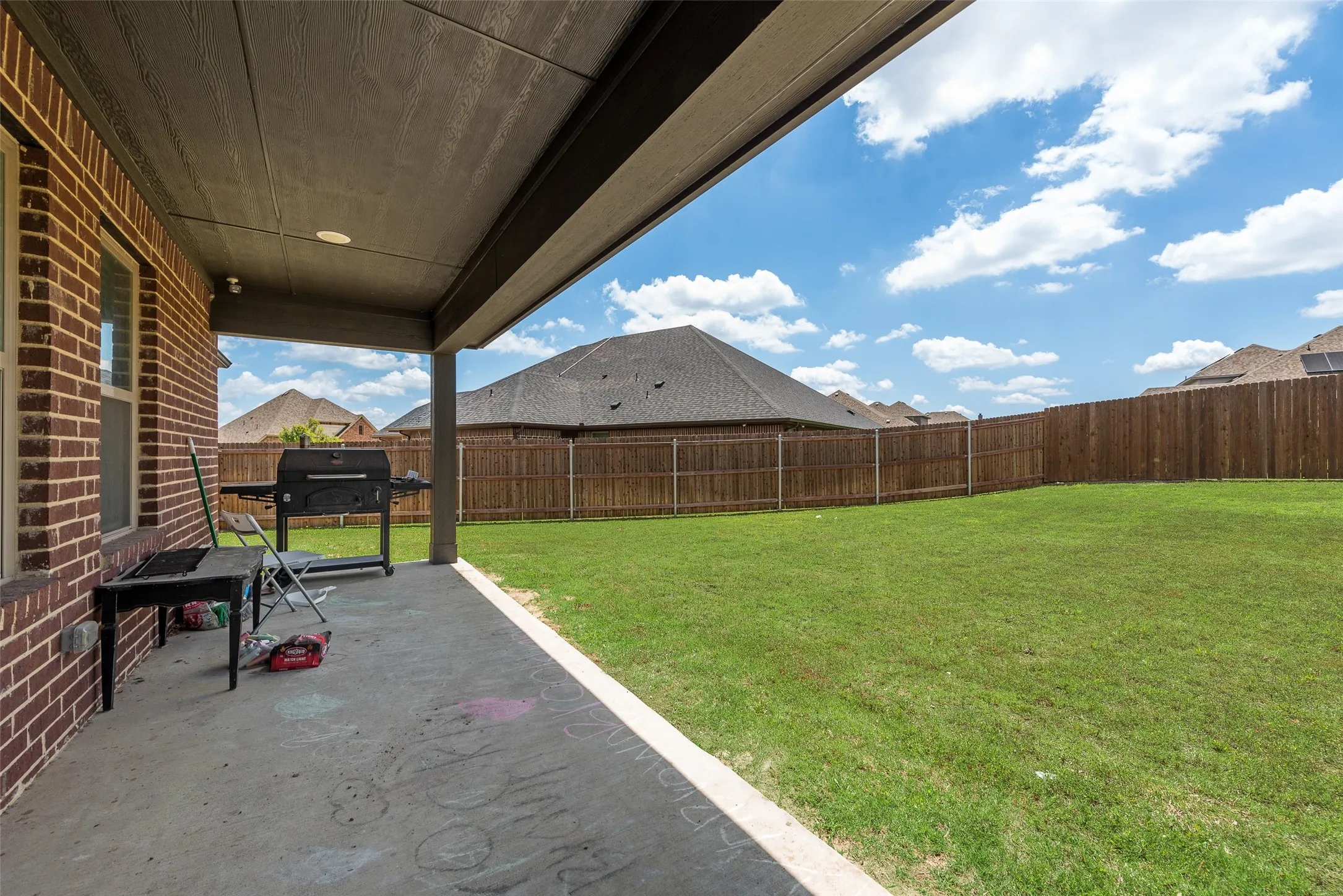 Fenced backyard featuring a patio