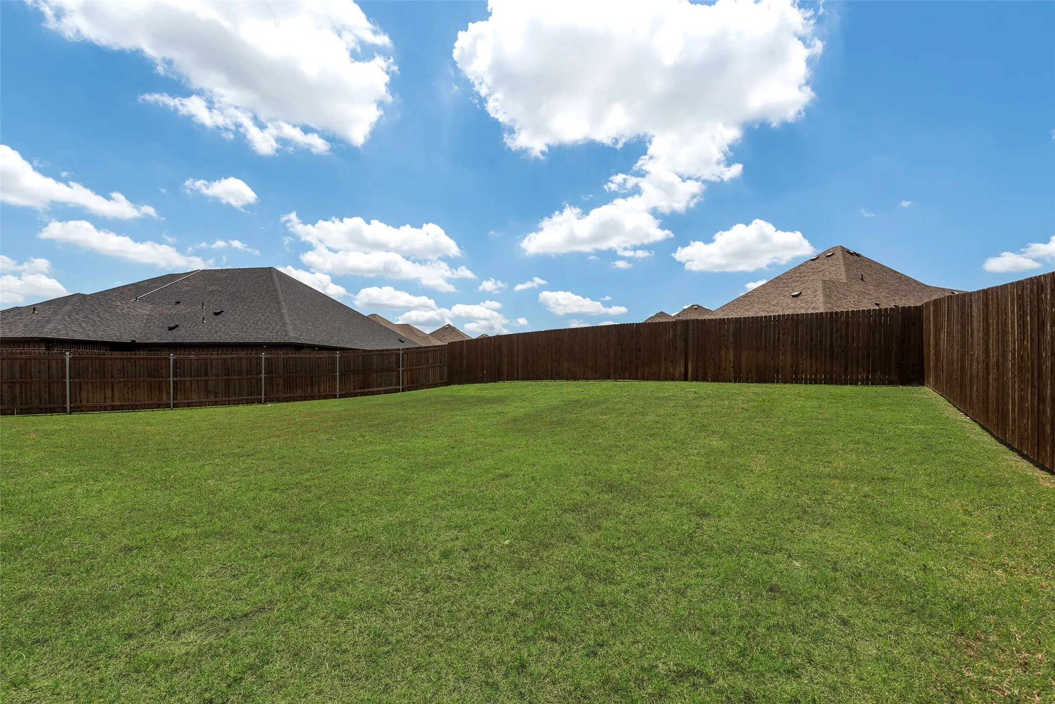 View of fenced backyard