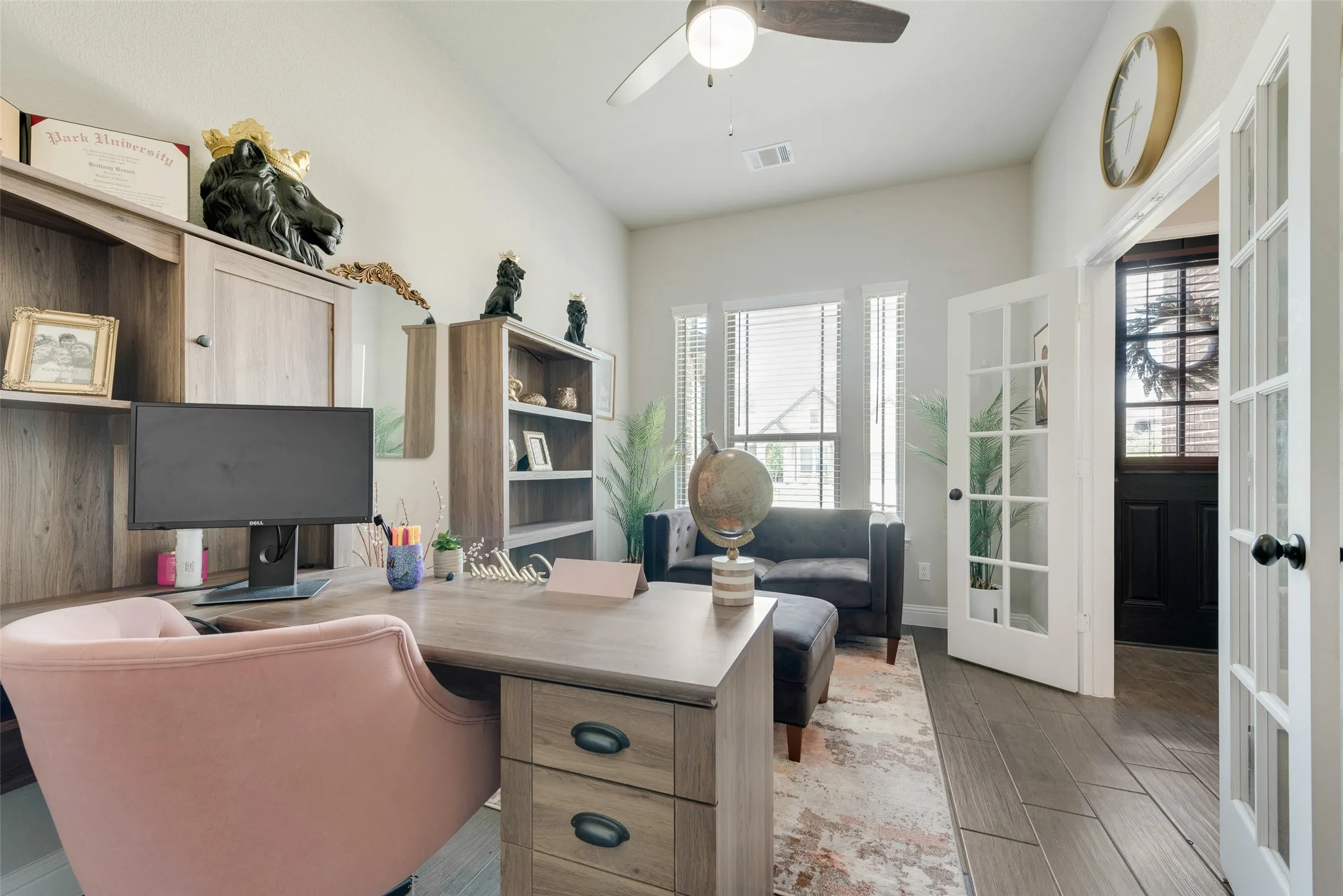 Office space or bedroom featuring french doors, plenty of natural light, wood finished floors, and a ceiling fan