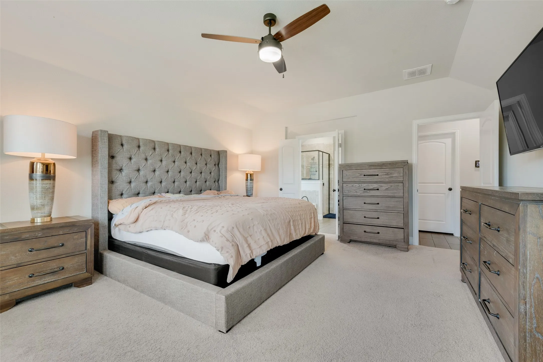 Bedroom featuring lofted ceiling, light carpet, and ceiling fan