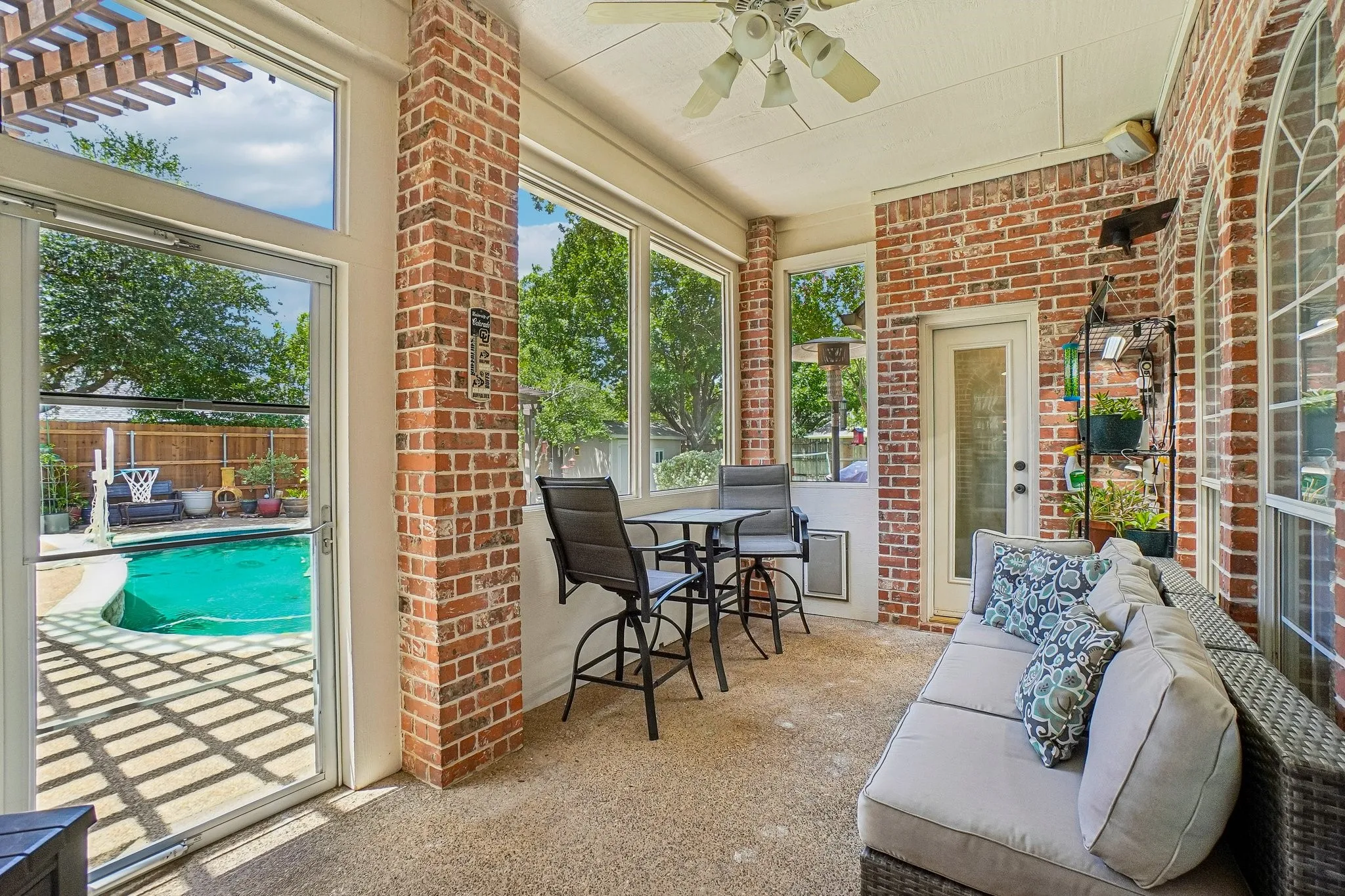 Screened sun room with access to the patio and pool area.