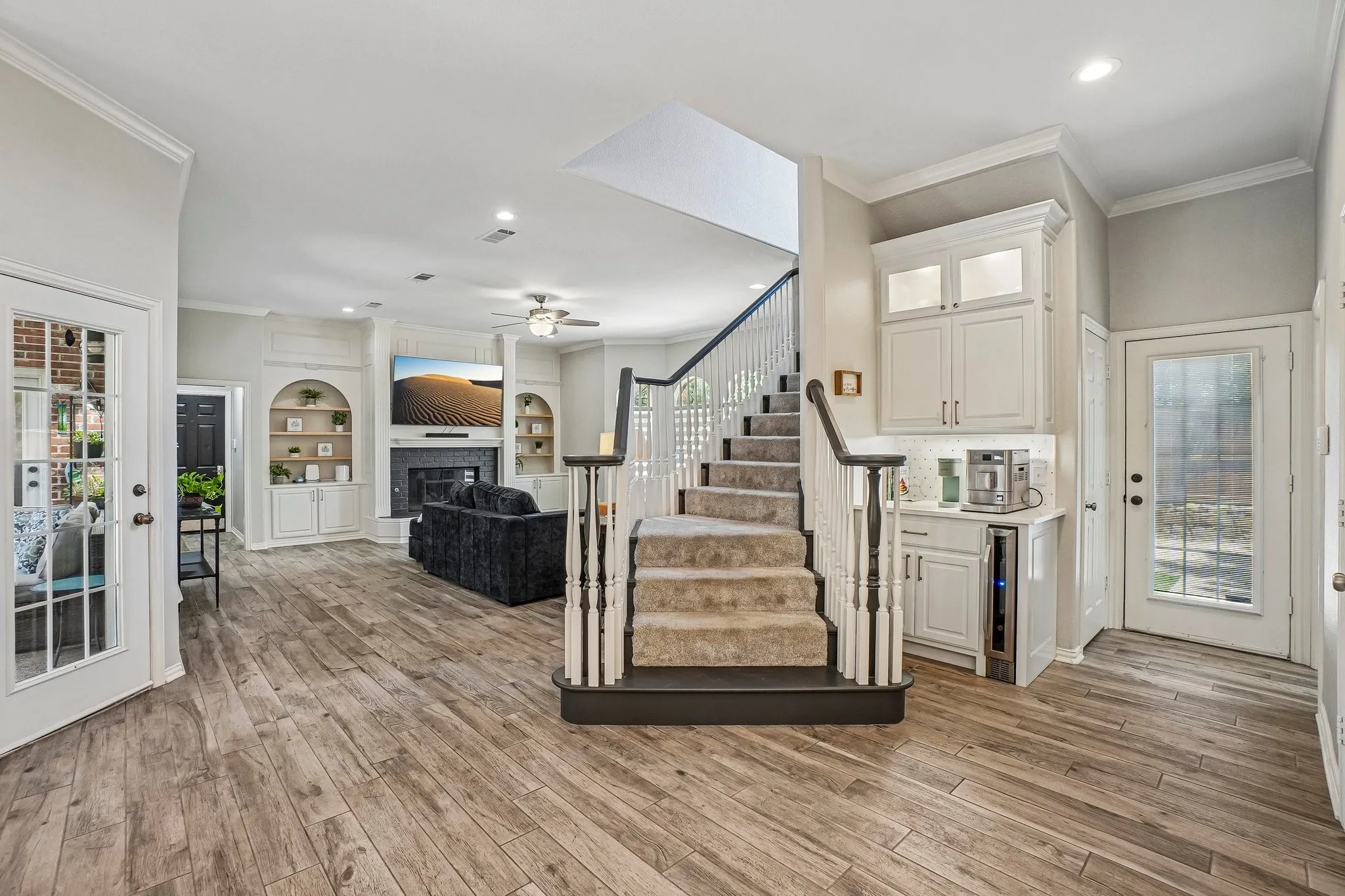 Views of the family room, stairway to second level and the coffee bar from the gourmet kitchen