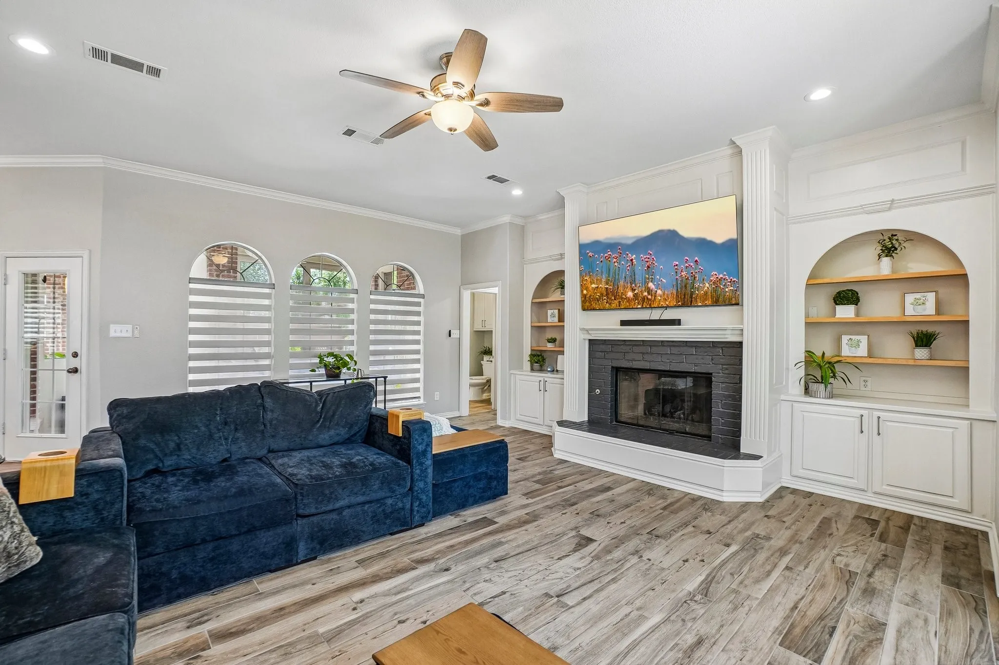 Living area featuring a ceiling fan with integrated lighting and views out to the pool area in back