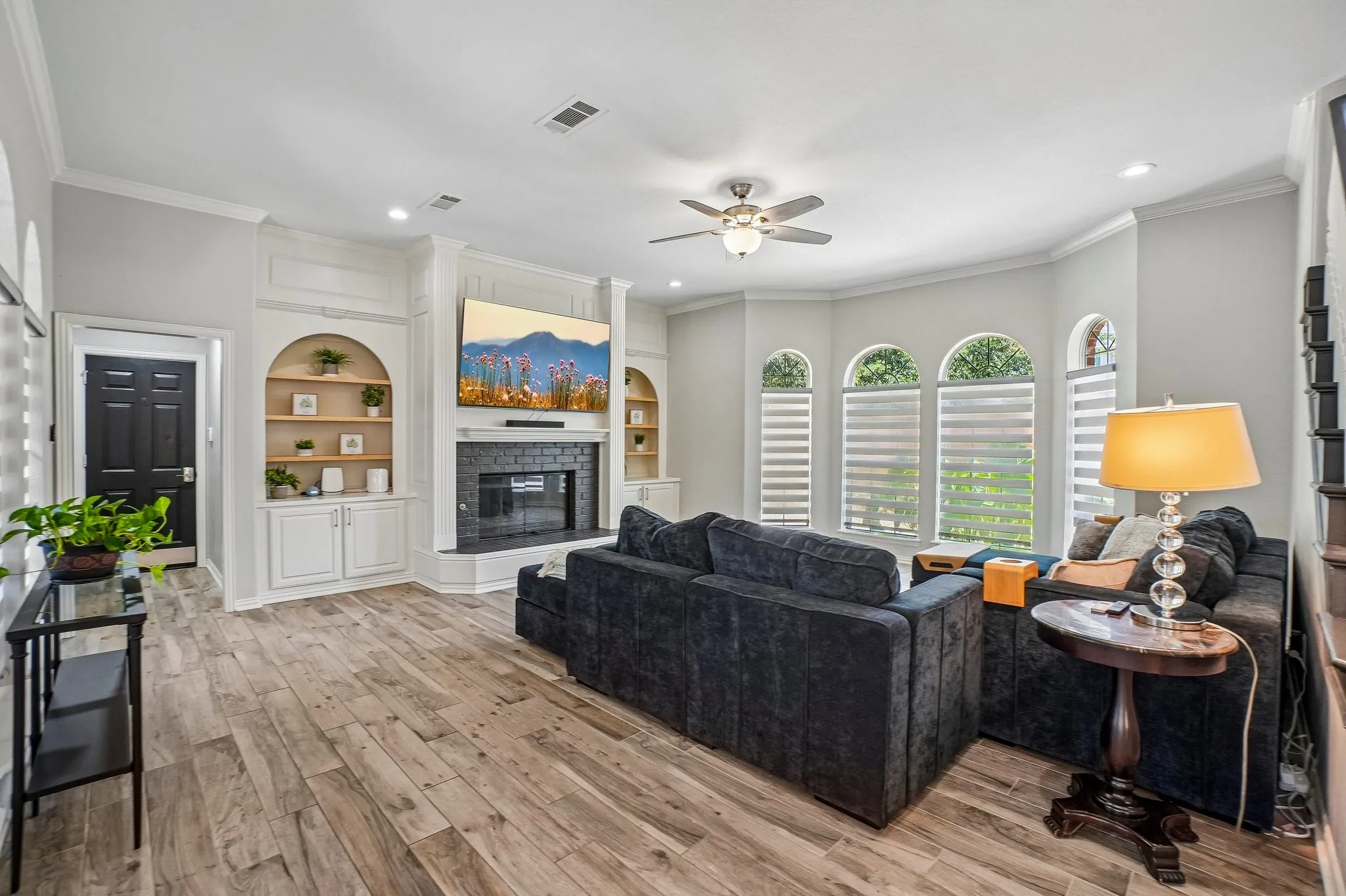 Dining room featuring wood-finish flooring, wainscoting, and crown molding