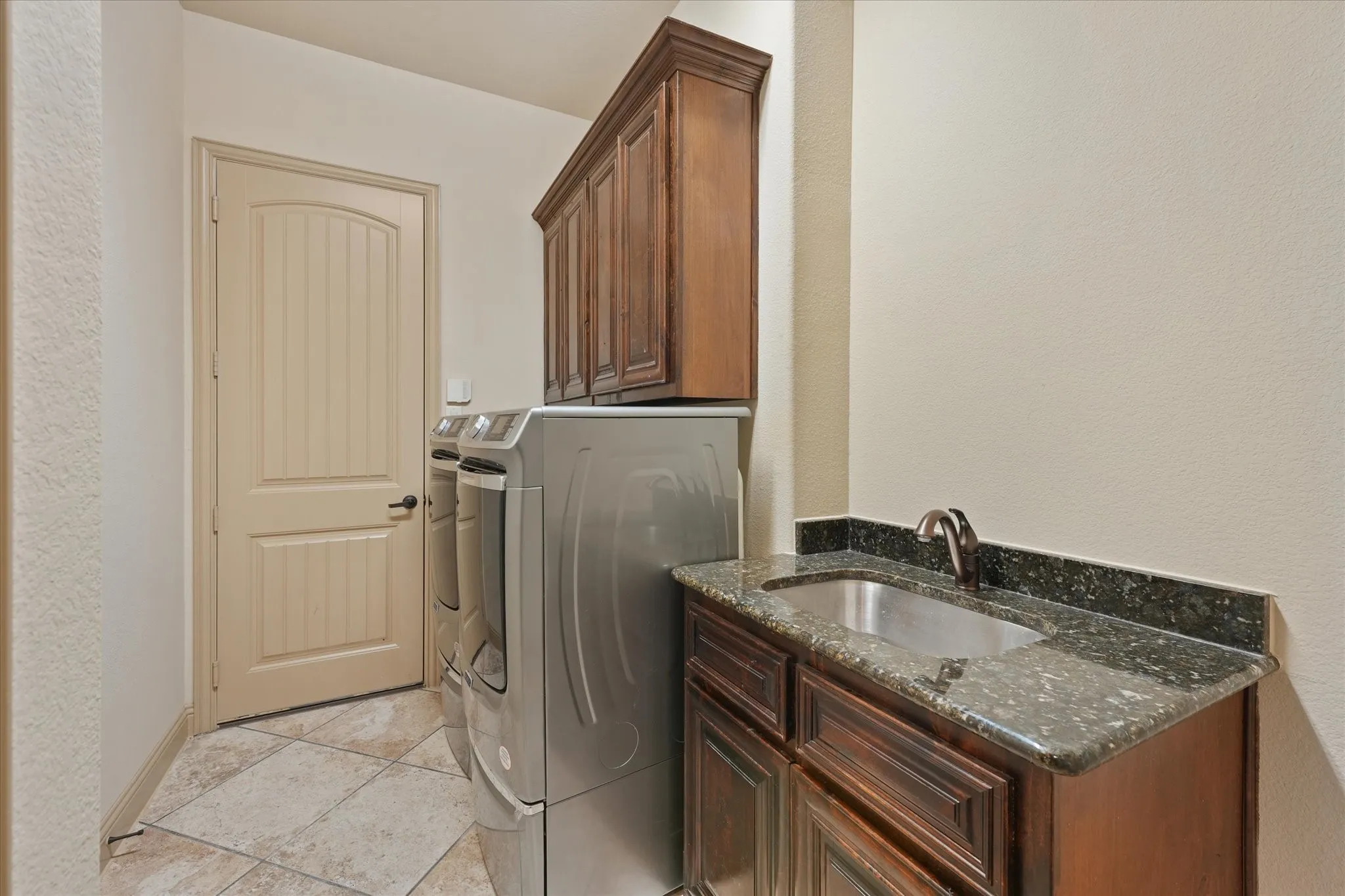 Full Sized Laundary Room with Built-in Cabinets