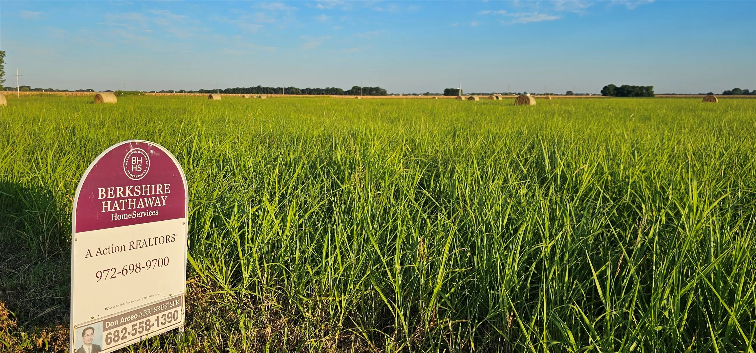 Expansive acreage featuring green vegetation under a clear sky