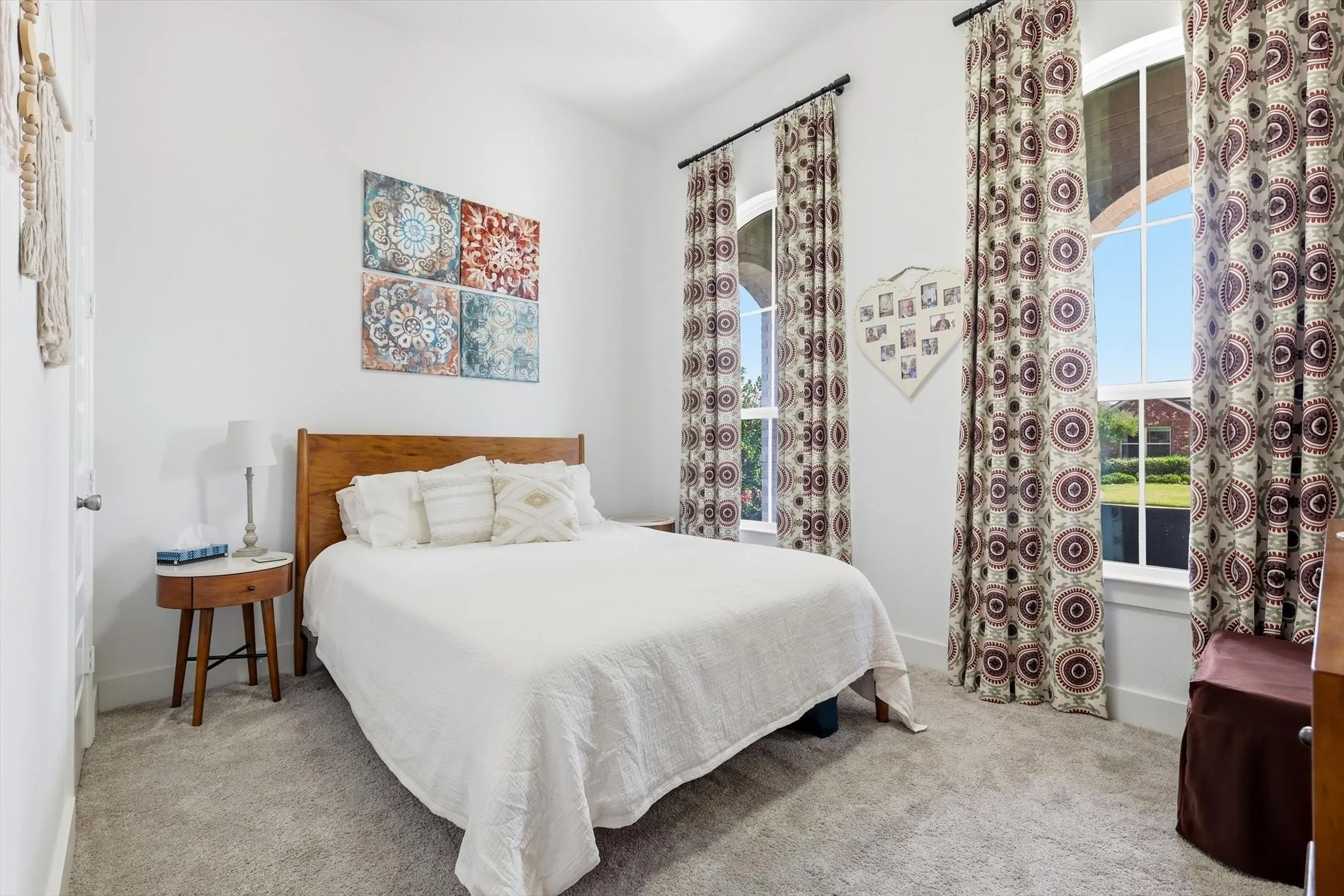 Carpeted bedroom with a light-colored wood headboard