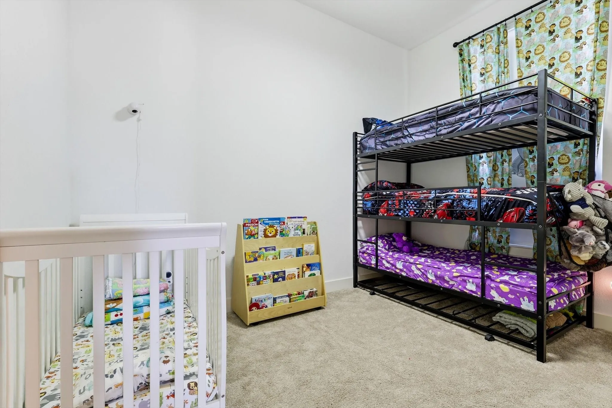 Spacious room featuring light gray carpeting and white walls