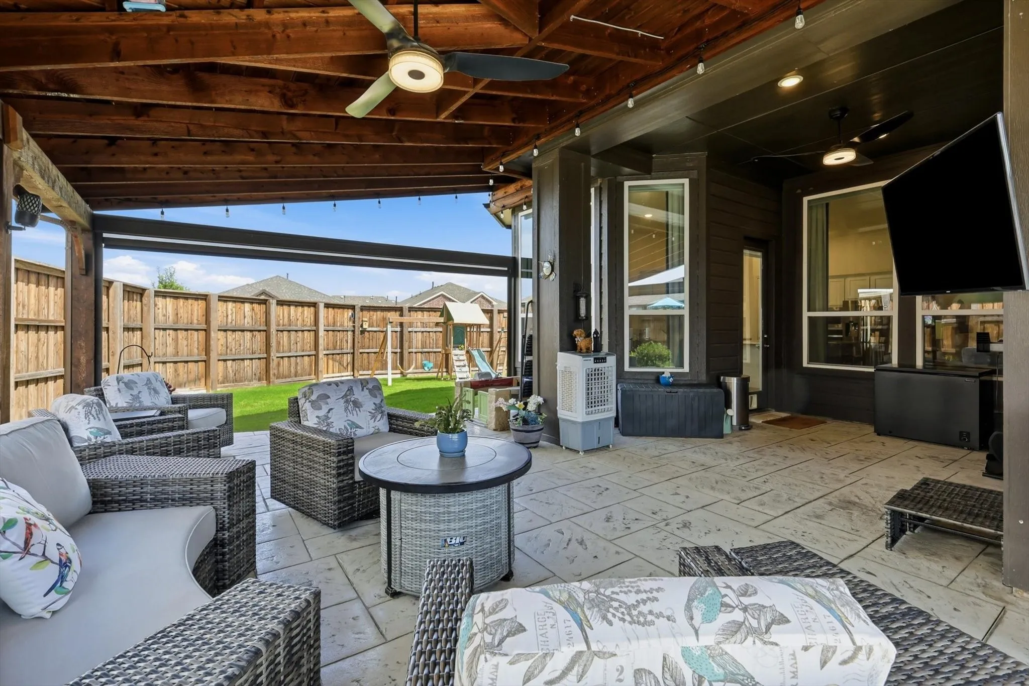 Covered patio featuring an exposed wood beam ceiling, ceiling fans, recessed lighting, and stamped concrete flooring