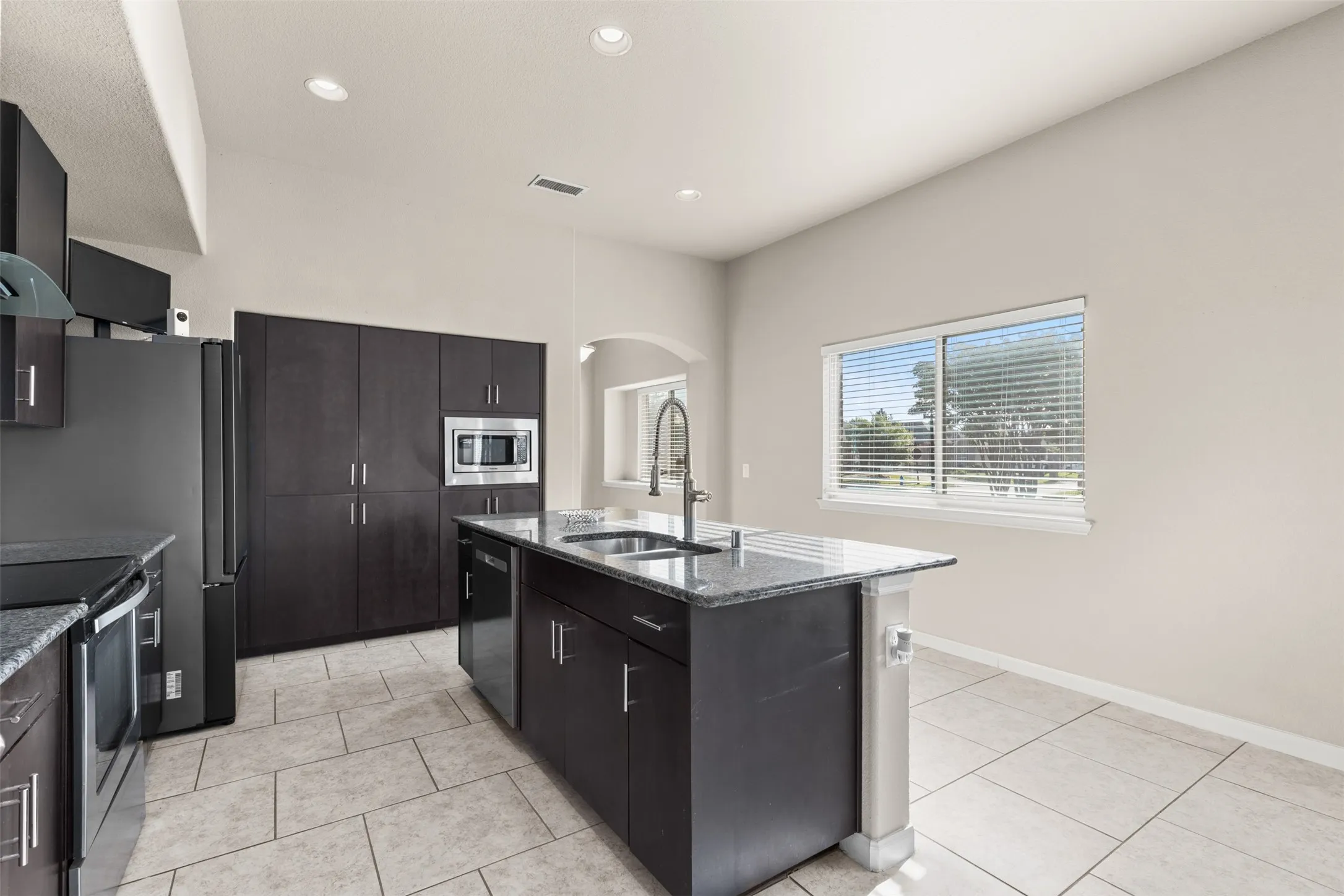 Lots of cabinet storage and can lighting in kitchen