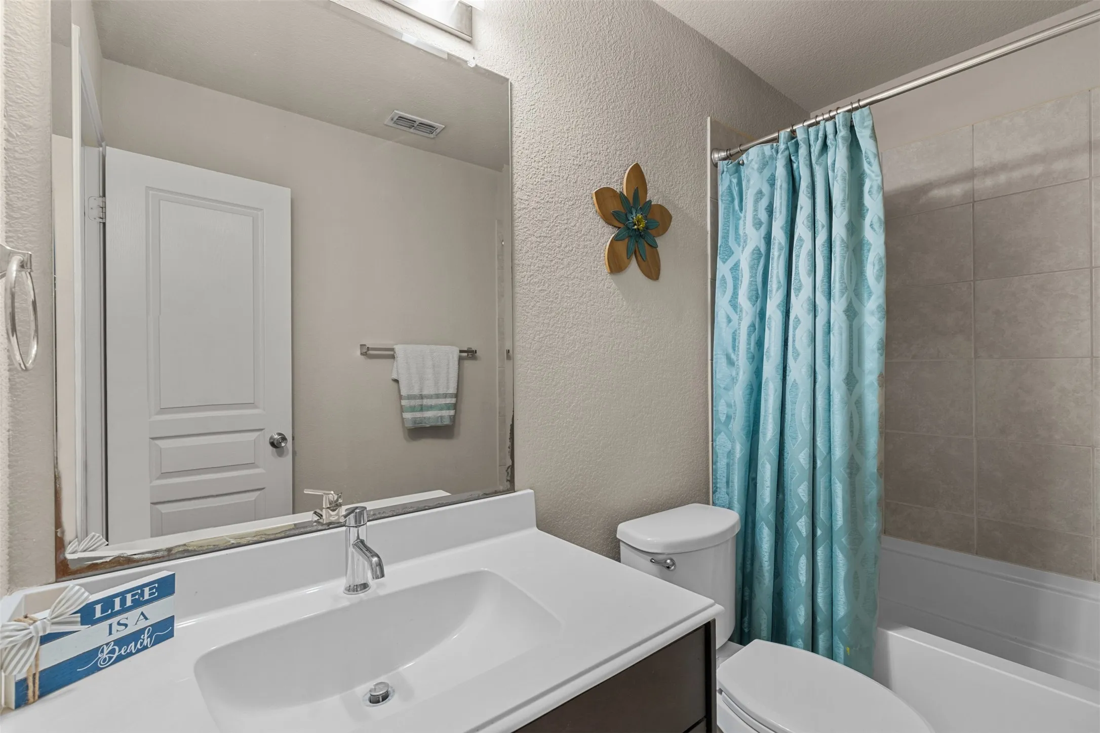 Second bathroom down features a combo tub-shower
