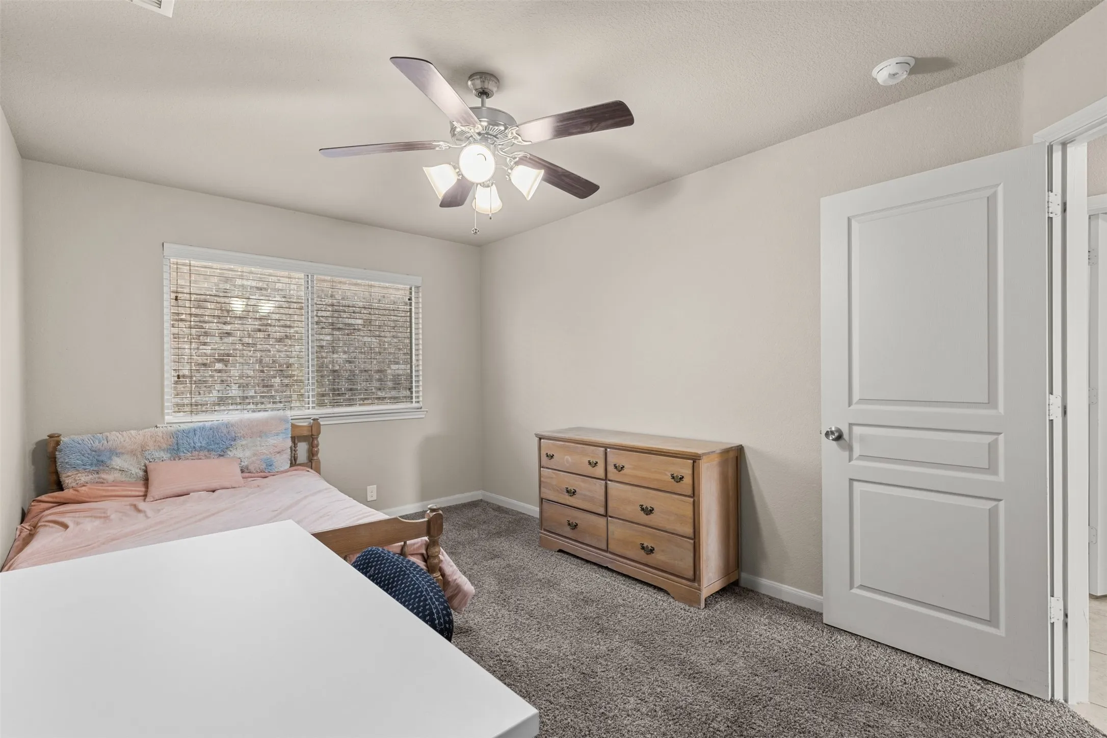 Features carpet, ceiling fan and window coverings